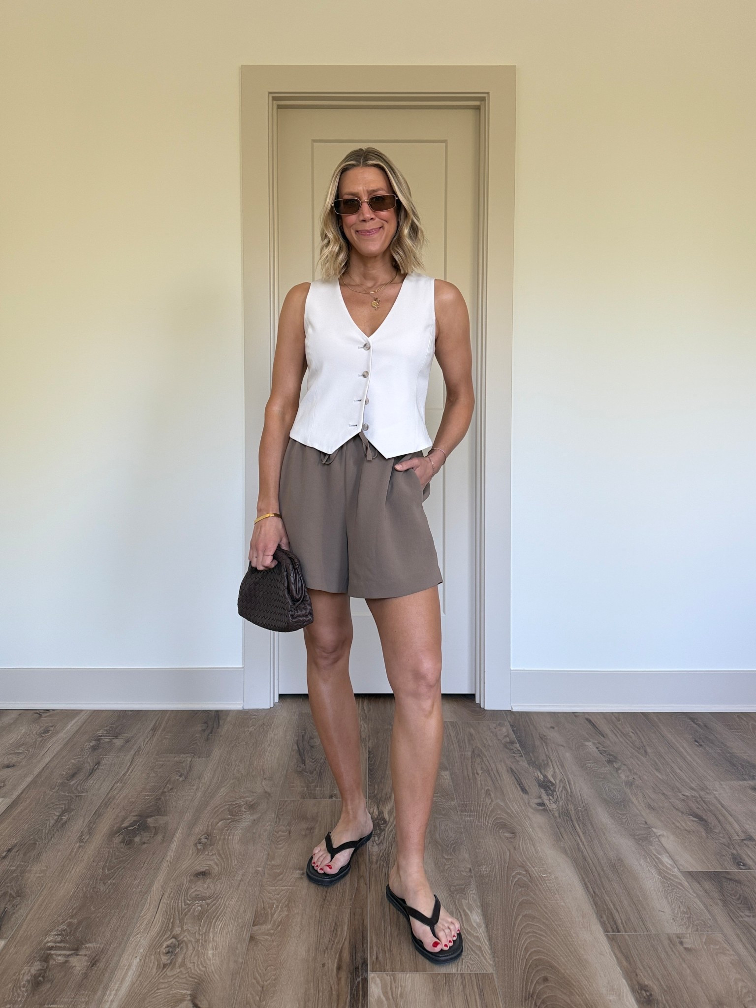 Wearing 2 vest, small shorts, sandals tts

#LTKSeasonal #LTKootd #LTKOver40