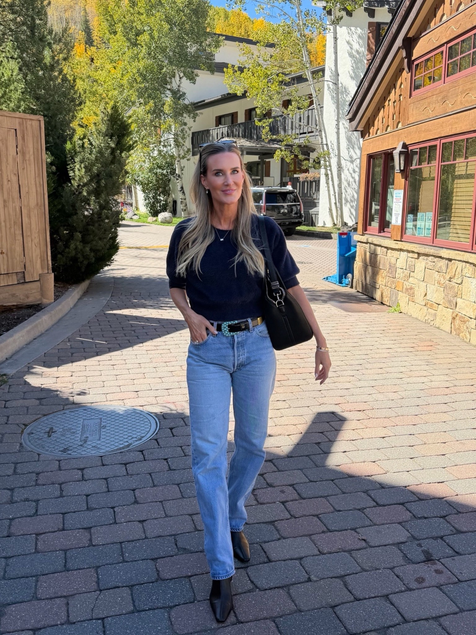 The perfect early fall outfit 🍂 A classic navy sweater paired with relaxed straight leg jeans, black ankle boots and a timeless black shoulder bag for an effortless elevated everyday look. I love this combination for crisp fall days, weekend plans, travel and casual dinners when you want to feel polished without trying too hard. These versatile wardrobe staples are easy to mix and match all season long.

Shop my fall outfit, denim, sweater, boots and accessories on LTK.