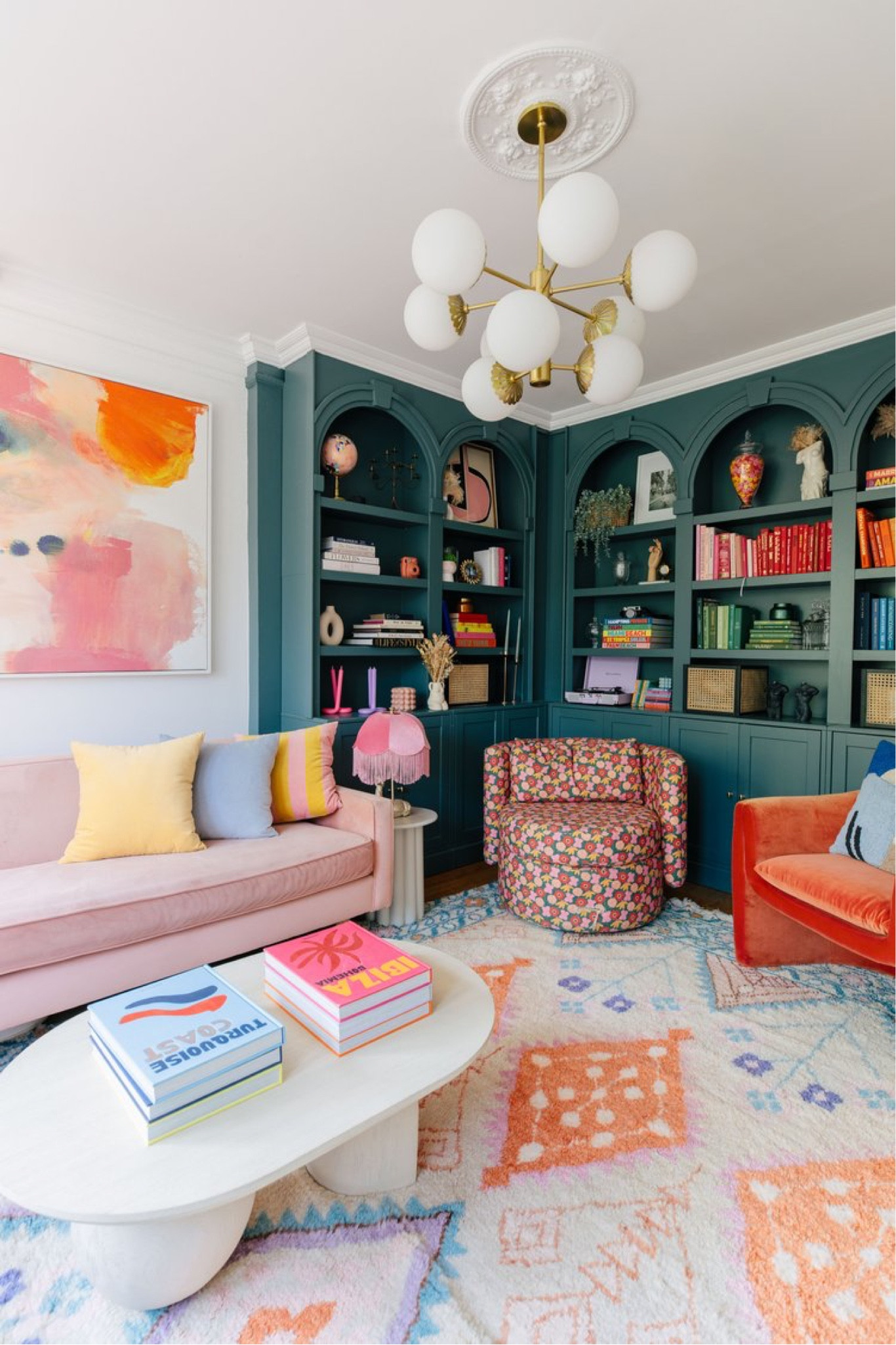Colorful dining room green built in bookcase styling anthro furniture pink sectional velvet chair floral chair 

#LTKhome