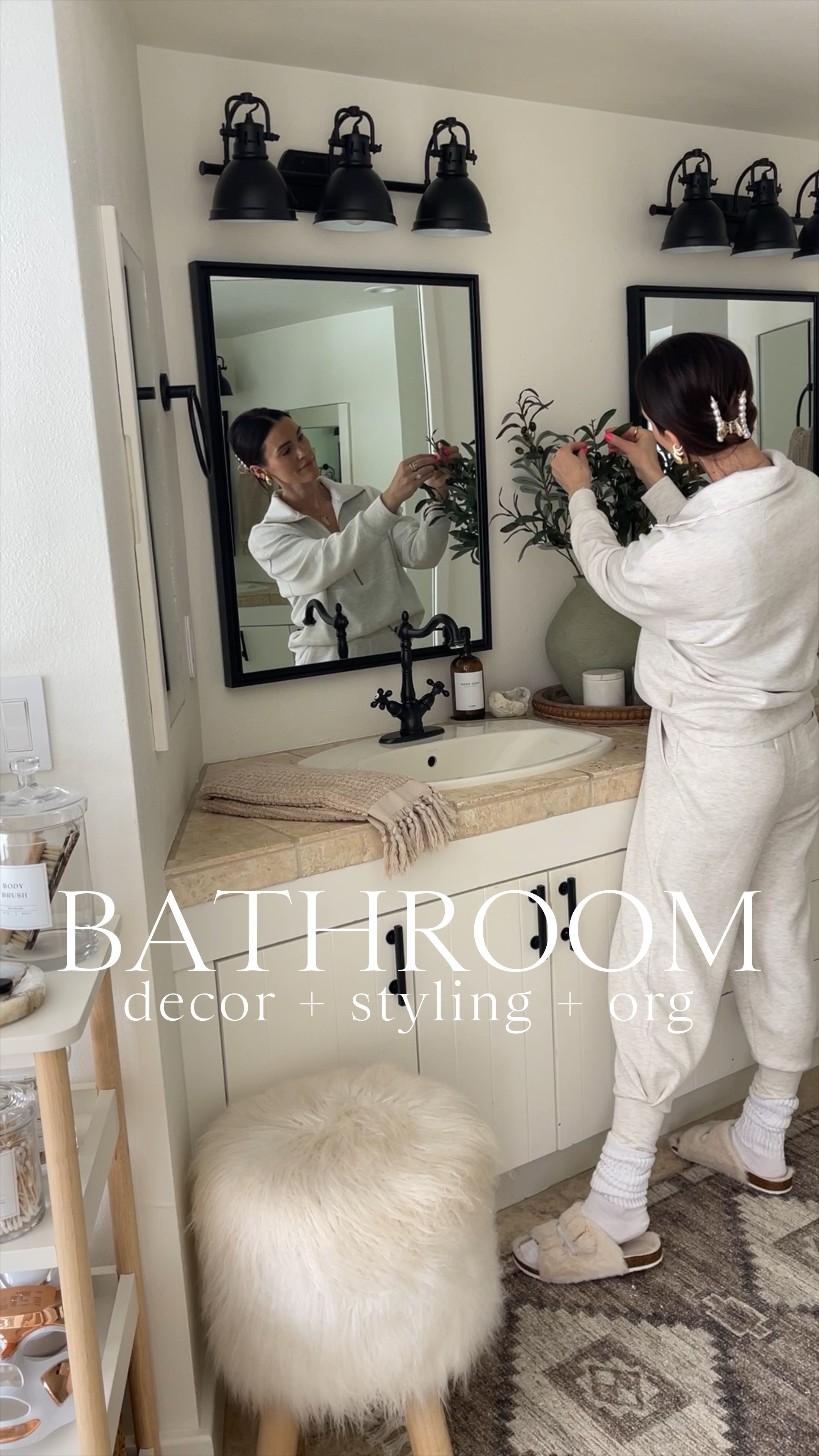 HOME \ Bathroom refresh🌿🧺 Styling out this space with new and old decor finds along with organization favorites! Many items from Amazon and Target! Here’s what I’m using👇🏻
+ wood tray
+ ceramic vase
+ faux olive branches (5 for $27)
+ marble canisters
+ mini cement trays 
+ glass soap bottles & labels
+ hand towels
+ runner rug $45
+ faux fur stool 
+ glass apothecary jars (set of 3)
+ custom labels
+ tissue box holder $12
+ woven basket 

#LTKfindsunder50 #LTKhome #LTKVideo