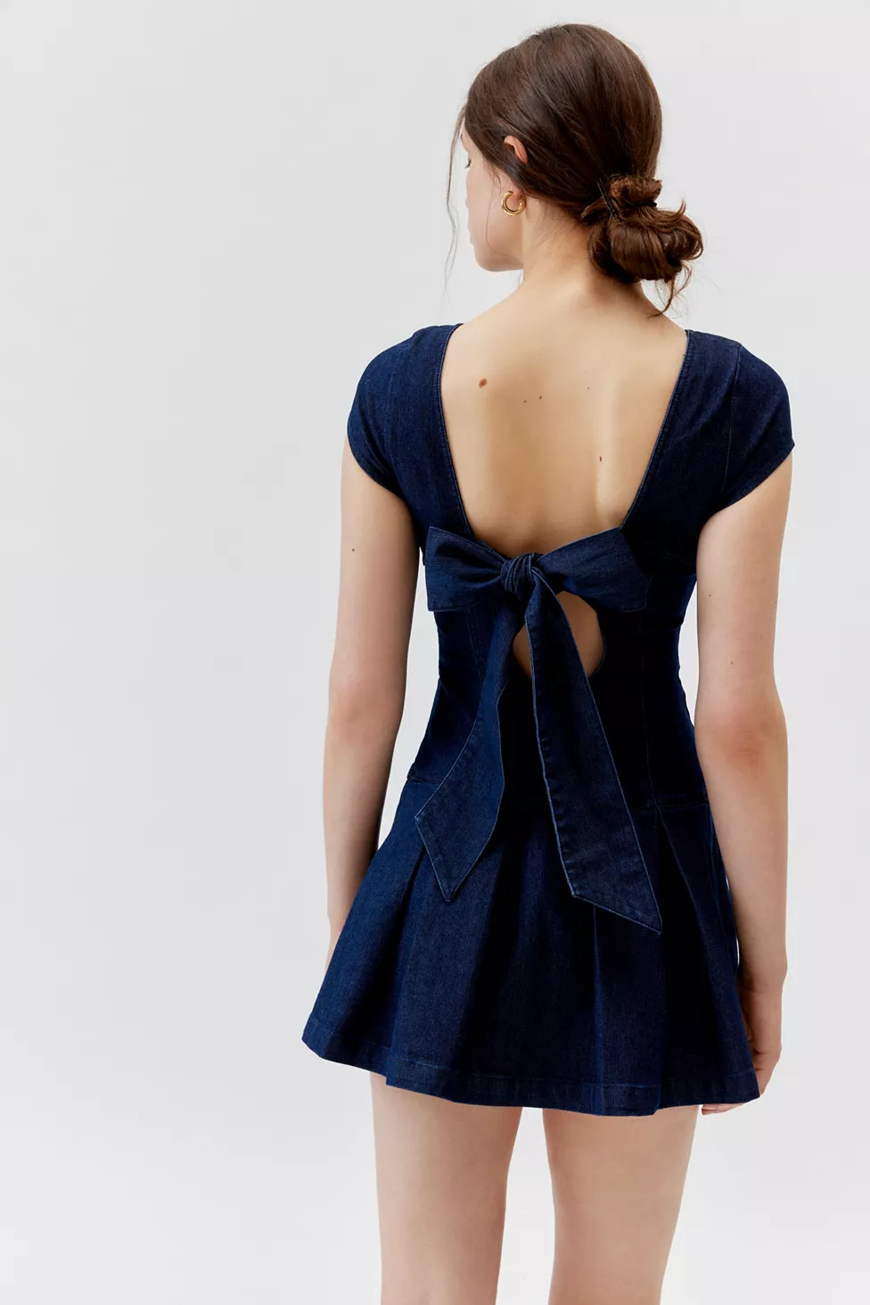 UO Bryan Bow-Back Pleated Denim Mini Dress | Urban Outfitters (US and RoW)