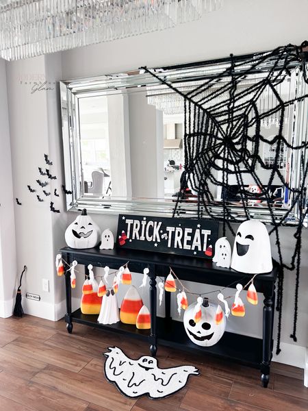 Halloween decor entryway table chandelier pumpkins spider web ghosts mirror at Modernfarmhouseglam 

#LTKSeasonal #LTKhome #LTKFind