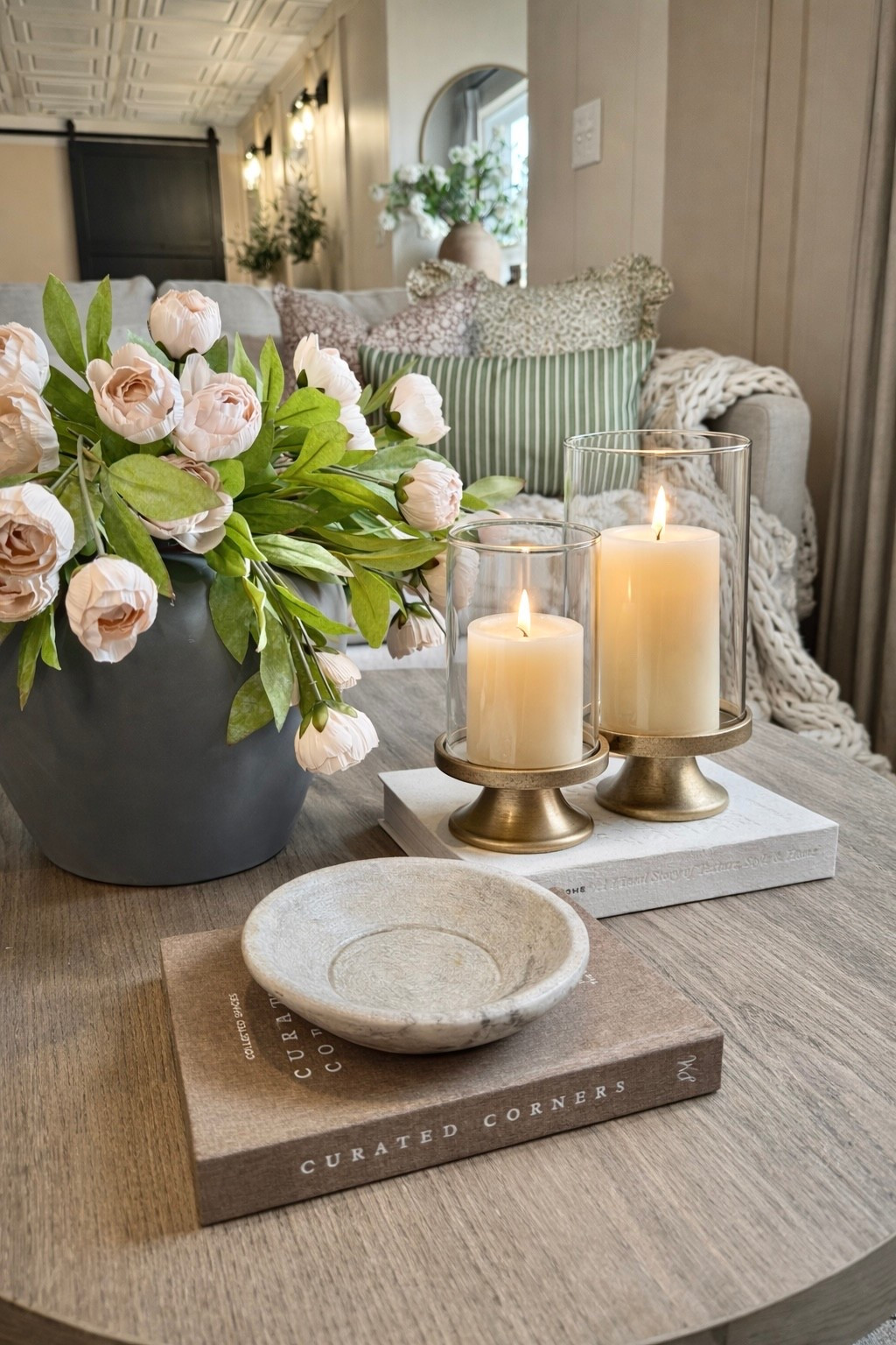 Why hasn’t anybody shared these yet?! 😍

Follow @farmtotablecreations on Instagram for more cozy, designer-inspired finds 🤍

This hurricane candle holder set from Amazon is one of those quiet luxury pieces that instantly elevates your space. The brass pedestal base paired with the glass cylinders gives that high-end, designer look you see styled in magazines—without the designer price tag.

I love how they add height and warmth to a coffee table, especially layered with books, a marble bowl, and soft florals like this. The glow is SO cozy at night and makes your whole space feel intentional and pulled together.

If you’ve been wanting that “styled but effortless” look… this is it.

#candleholders #coffeetabledecor #livingroomdecor #homedecor #decorfinds

coffee table decor | hurricane candle holders | brass decor | glass candle holders | neutral home decor | living room styling | cozy home | designer look for less | amazon home finds | home styling ideas | neutral aesthetic | coffee table styling | decorative accents | home decor ideas | modern classic decor | warm neutral decor | living room inspo | interior styling | affordable decor | candle decor | brass accents | layered decor | home details | neutral living room | decor inspiration

#LTKHome #LTKSaleAlert