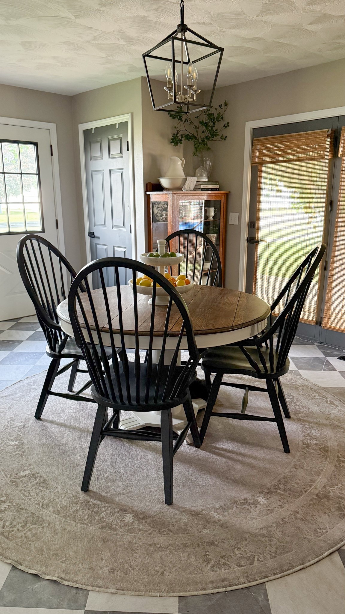 Farmhouse Dining Room.

Checkered flooring | Peel & Stick Floor Tiles | Modern Lantern Pendant | Windsor Dining Chairs | Solid Wood Dining Chairs | Marble Fruit Stand | Round Dining Table | Bamboo Blinds | Antique Plate Collection |