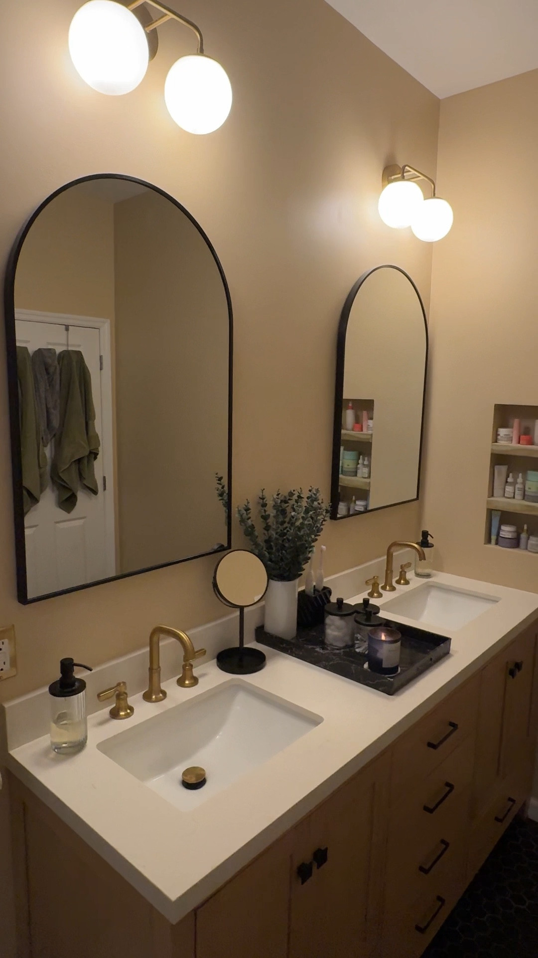 A look at our bathroom renovation transformation! We decided to do a neutral and calm setup for the primary bathroom. The double vanity, all the tile, shower door and toilet are from The Home Depot. The arch mirrors are Wayfair and the lights are from Lowe’s. We also added a built-in shelf! 

#LTKHome #LTKFindsUnder100