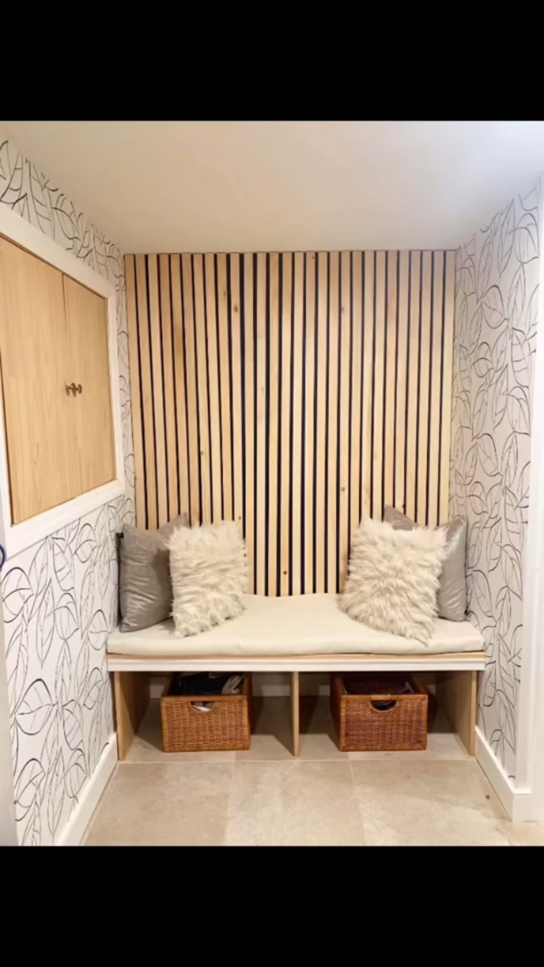 A stylish storage space makeover featuring slat wood wall panels, peel and stick wallpaper, a functional entryway bench with storage bins, and decorative pillows for a layered and inviting look. Links to all featured products are listed below.

#LTKHome