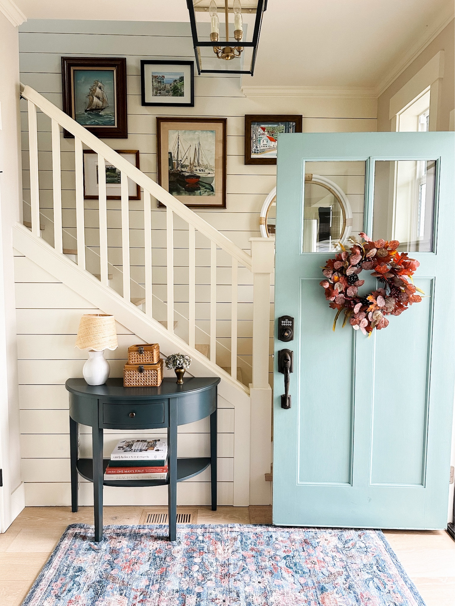 Entry decor - fall entryway styling. Demilune table, autumn wreath, lamp scalloped shade, floral rug, woven rattan storage boxes, book stack, rug pad 

#LTKHome #LTKSeasonal #LTKStyleTip