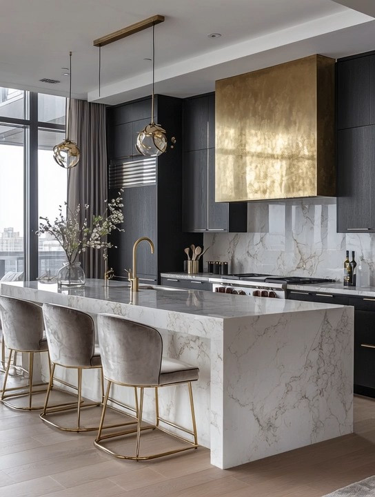 Gold, gray, black, and velvet—this is where modern luxury meets timeless design.

This kitchen is elevated by statement pieces that do all the work: a sculptural gold faucet, plush velvet kitchen island chairs, and a refined palette of gold with black, gray, ivory, and white stone. The contrast is intentional—soft velvet against sleek marble, warm gold against grounded black and gray—creating a kitchen that feels bold yet balanced.

Every element here is a design anchor. Gold brings warmth and elegance, black adds depth, gray grounds the space, and ivory softens the overall look. Together, these tones transform the kitchen island into the heart of the home—functional, striking, and undeniably sophisticated.

This is not trend-driven décor. This is statement living, built around materials and finishes that never go 

 #LTKHome
