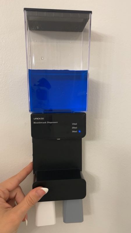 Bathroom must have! This automatic mouthwash dispenser not only lets you measure out how many ML you want, but also has magnetic cups that prevent spills or messes. 💕 Can either be hung up with provided nails and/or adhesive and would be perfect to put inside your shower as well! Two different colored cups to know who’s is who’s, and conveniently hang upside down so they can stay clean and dry 🦷🪥

#bathroomhack #bathroomfinds #bathroommusthave 

#LTKFindsUnder50 #LTKHome #LTKFindsUnder100