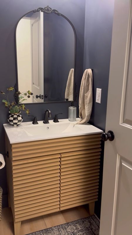 Half bathroom project is complete! We painted the walls hail navy by, laid LVP flooring and put in a beautiful and affordable vanity! 

#LTKhome #LTKfindsunder100 #LTKVideo