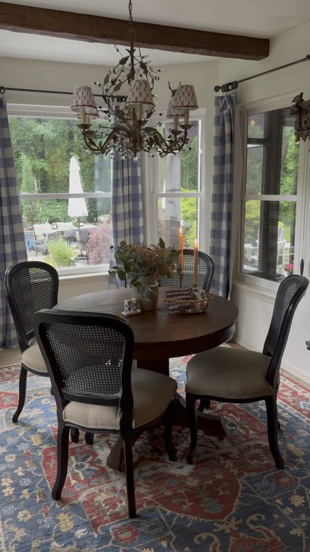 Cottage style decor, crystal chandelier and pleated chandelier lamp shades, block print lamp shades, cane dining chairs, black dining chairs, beautiful and colorful rug, Ralph Lauren home, gingham curtain panels, buffalo plaid drapes, breakfast nook inspo, faux wood rustic beams

#LTKVideo #LTKfindsunder50 #LTKhome