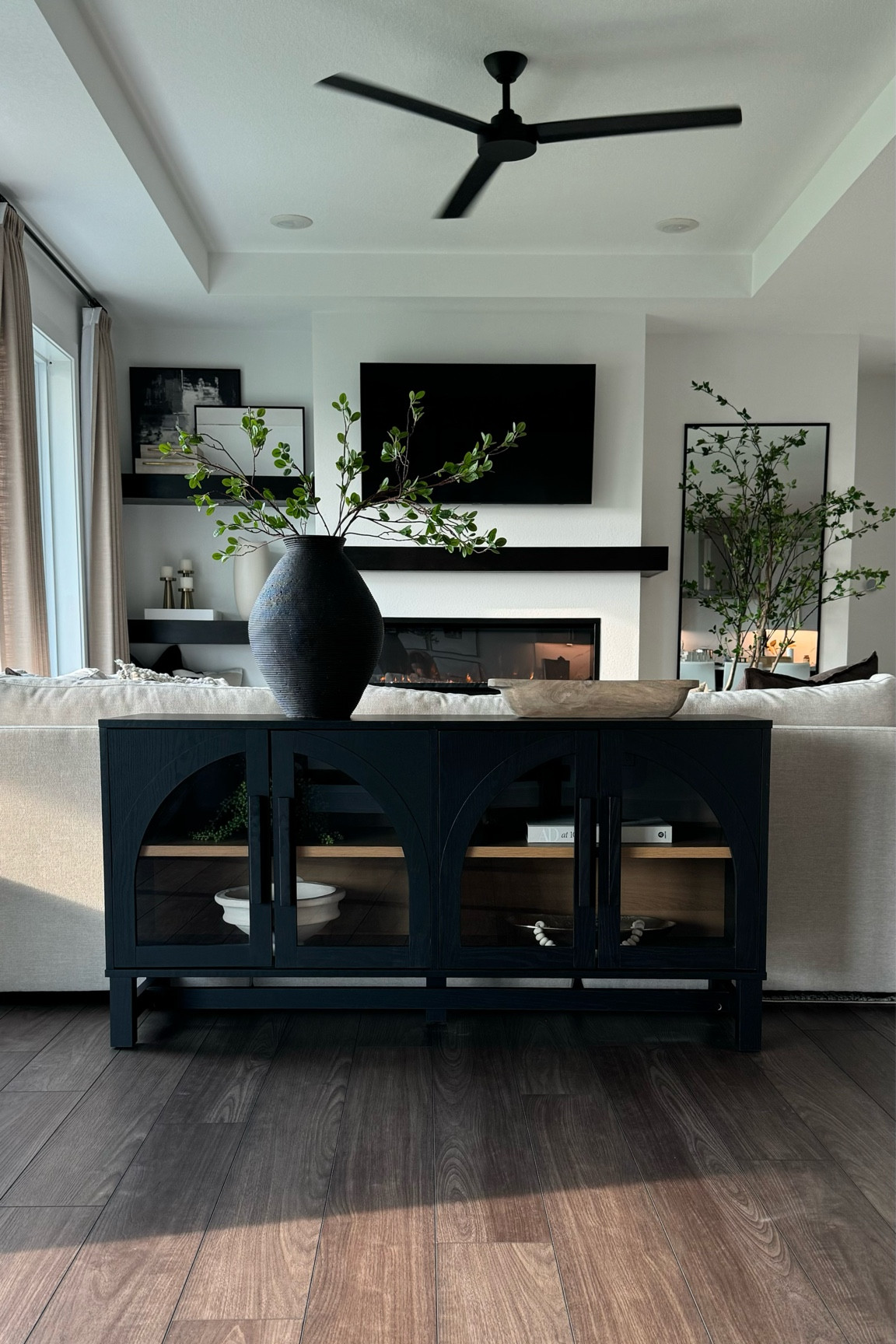 Modern living room decor. I love this arched media console cabinet from Walmart. This Amazon vase brings all the texture. 

#LTKStyleTip #LTKHome #LTKFindsUnder100