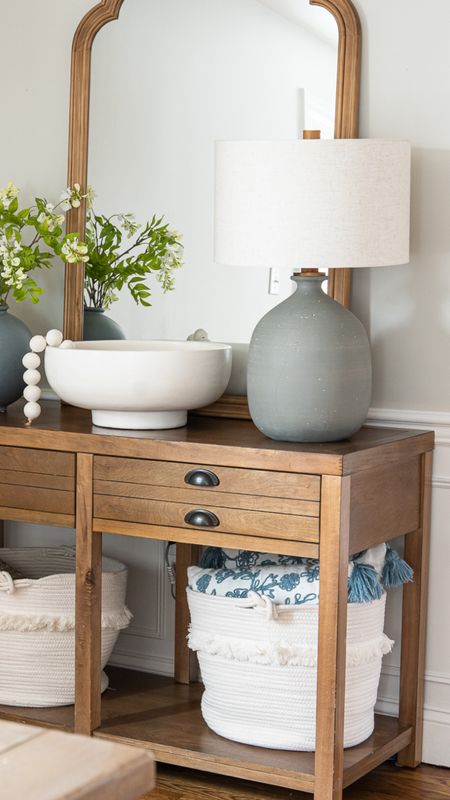 Simple console table with natural wood, lamps, faux greenery, throw pillows, rope storage bins #homedecor 

#LTKfamily #LTKhome