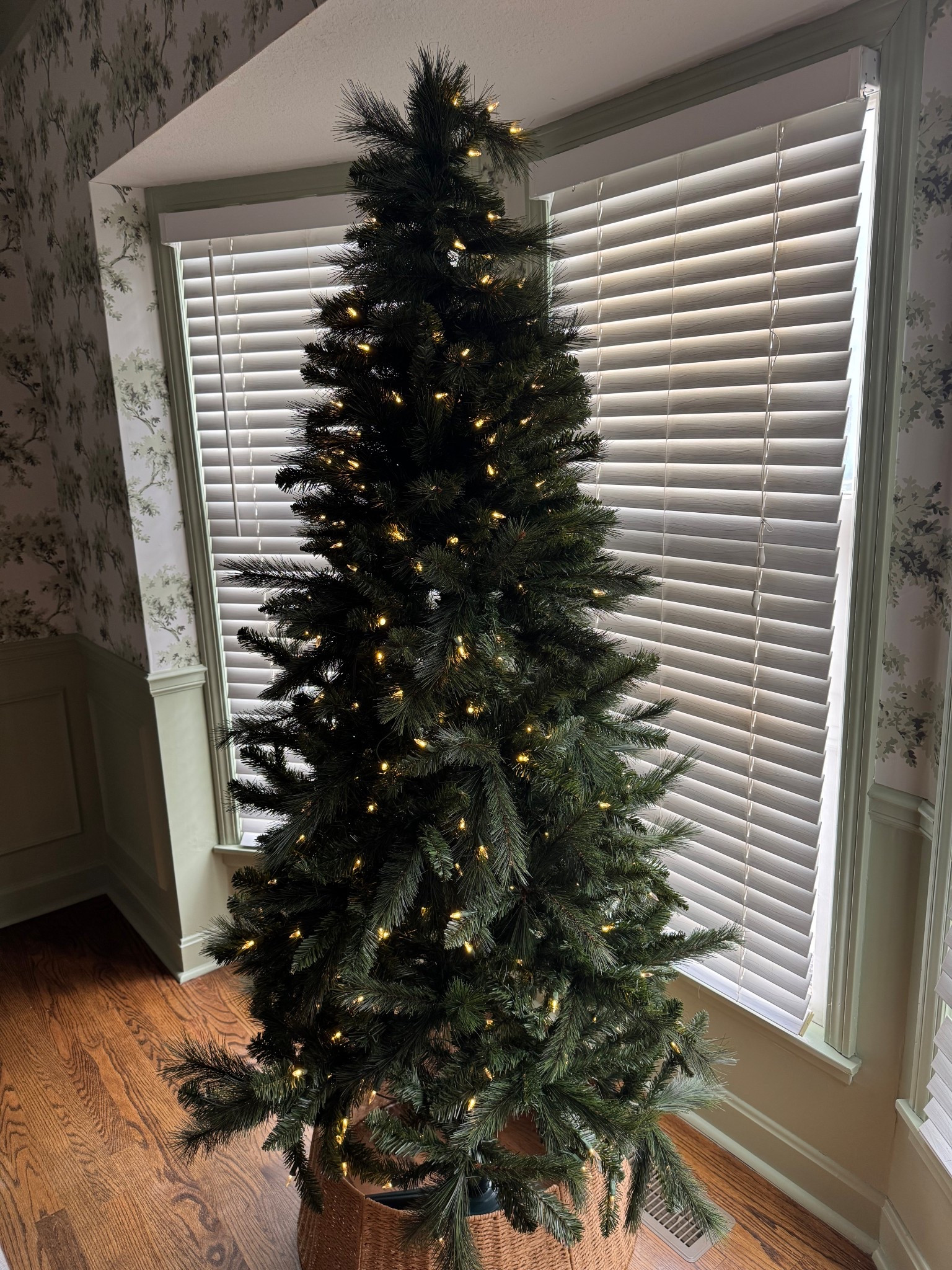 Prelit Christmas tree with auto plug lights.  I am impress with how full it looks and little to no fall out when fluffing! Cute wicker tree skirt as well. 

#LTKHome #LTKFamily #LTKHoliday
