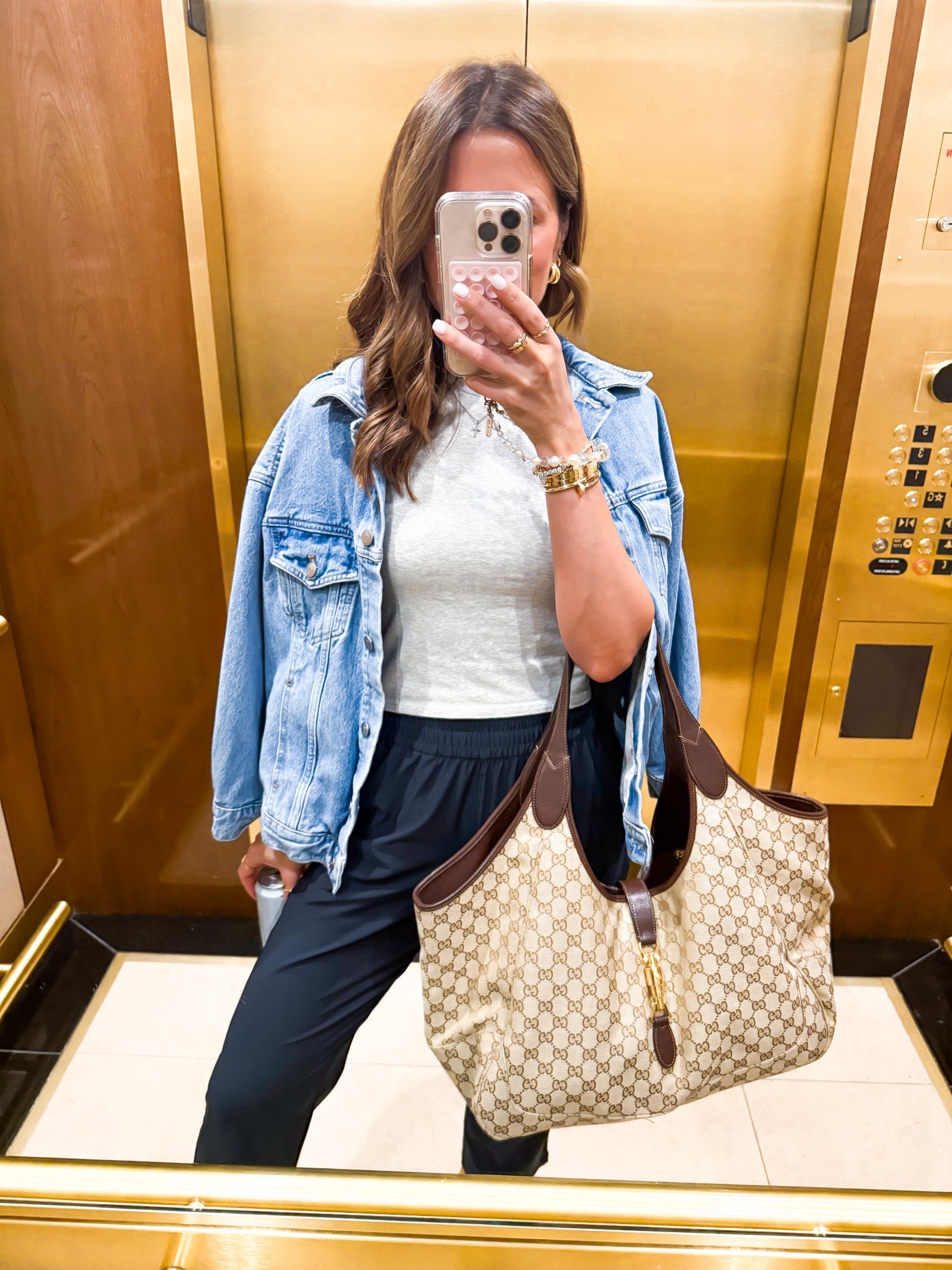 Gucci Mercato tote in large. My travel outfit of the day. I love these drapey ankle pants! Wearing XS. Travel outfits. Everyday outfits. Baby tee in XS. Elevated casual. Business casual. Wrinkle resistant and so comfortable! XXS petite in denim jacket. Jelly flats are whole sizes onmy - I’m a 6.5 and did a 6. 

#LTKPetite #LTKootd #LTKTravel