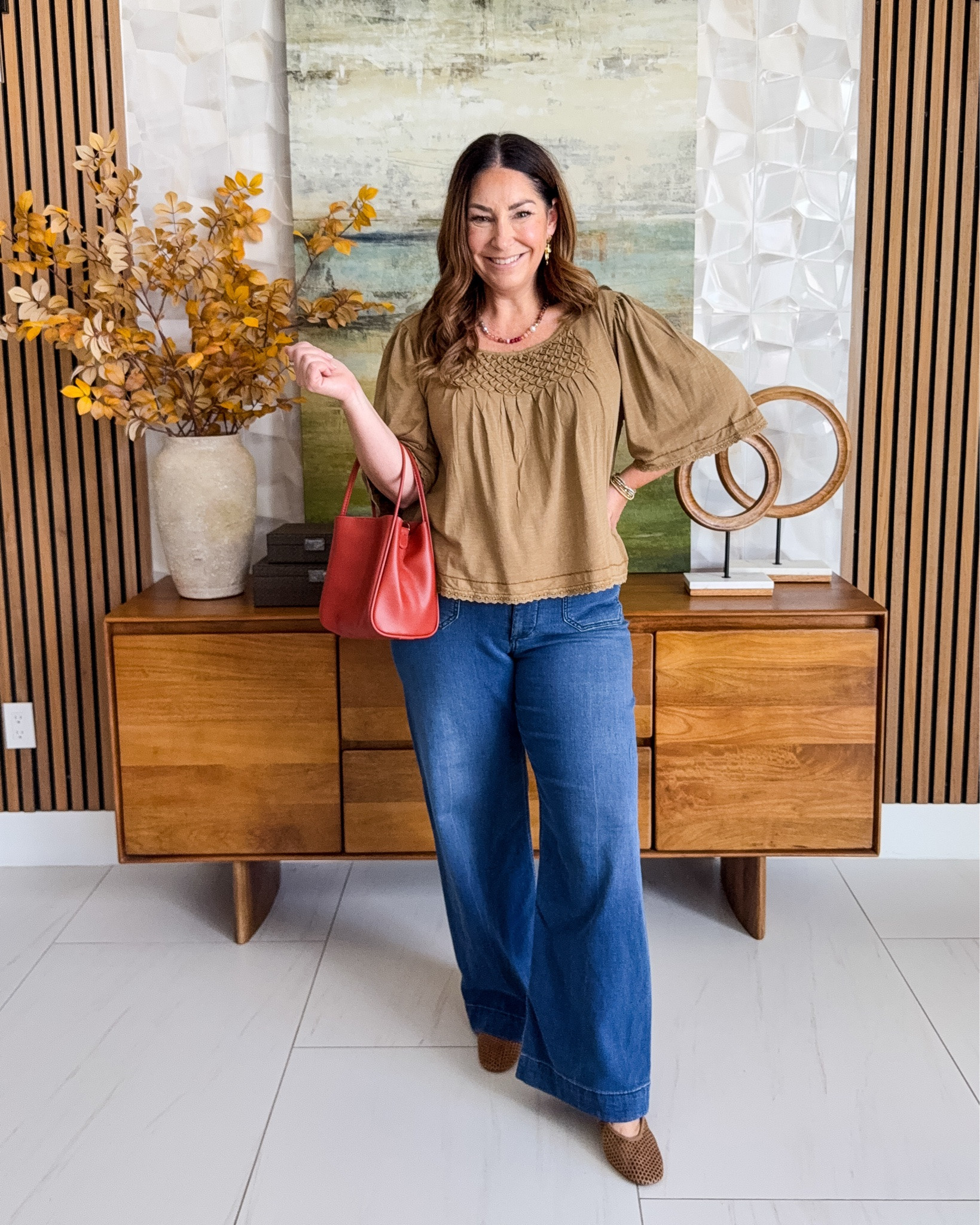The smocked neckline and flutter sleeves on this top are everything. 🍂 Comfy cotton, and a little pop of color in the bag makes it feel extra. 📏Wearing Top tts, L | Jeans size down, 30

#LTKSeasonal #LTKOver40 #LTKMidsize