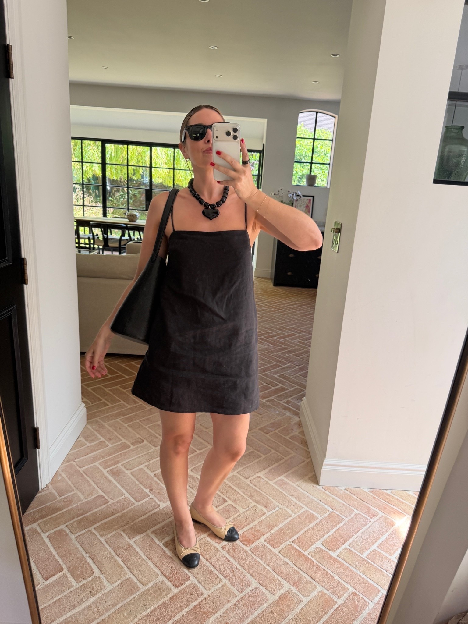 black linen slip dress, black mini dress, spaghetti strap dress, a-line slip dress, chunky beaded necklace, heart pendant necklace, statement necklace, two-tone ballet flats, cap toe flats, black and tan flats, black slouchy shoulder bag, black tote bag, black sunglasses, little black dress, evening ready look, quiet luxury, elevated basics, effortless summer style, minimalist chic, ltkstyletip, ltkseasonal, ltksummer, ltkfindsunder100, outfit inspo, capsule wardrobe essentials

#LTKsummer #LTKpartywear #LTKdresses
