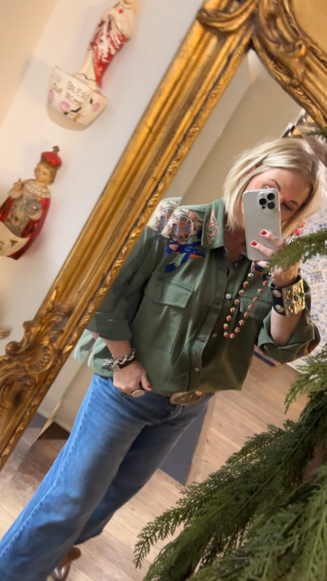 I purchased my regular size in this top and it’s very loose, easily could have sized down!!! Up to how you like the fit. Boots work great with the look and wide leg fit of the jeans. 