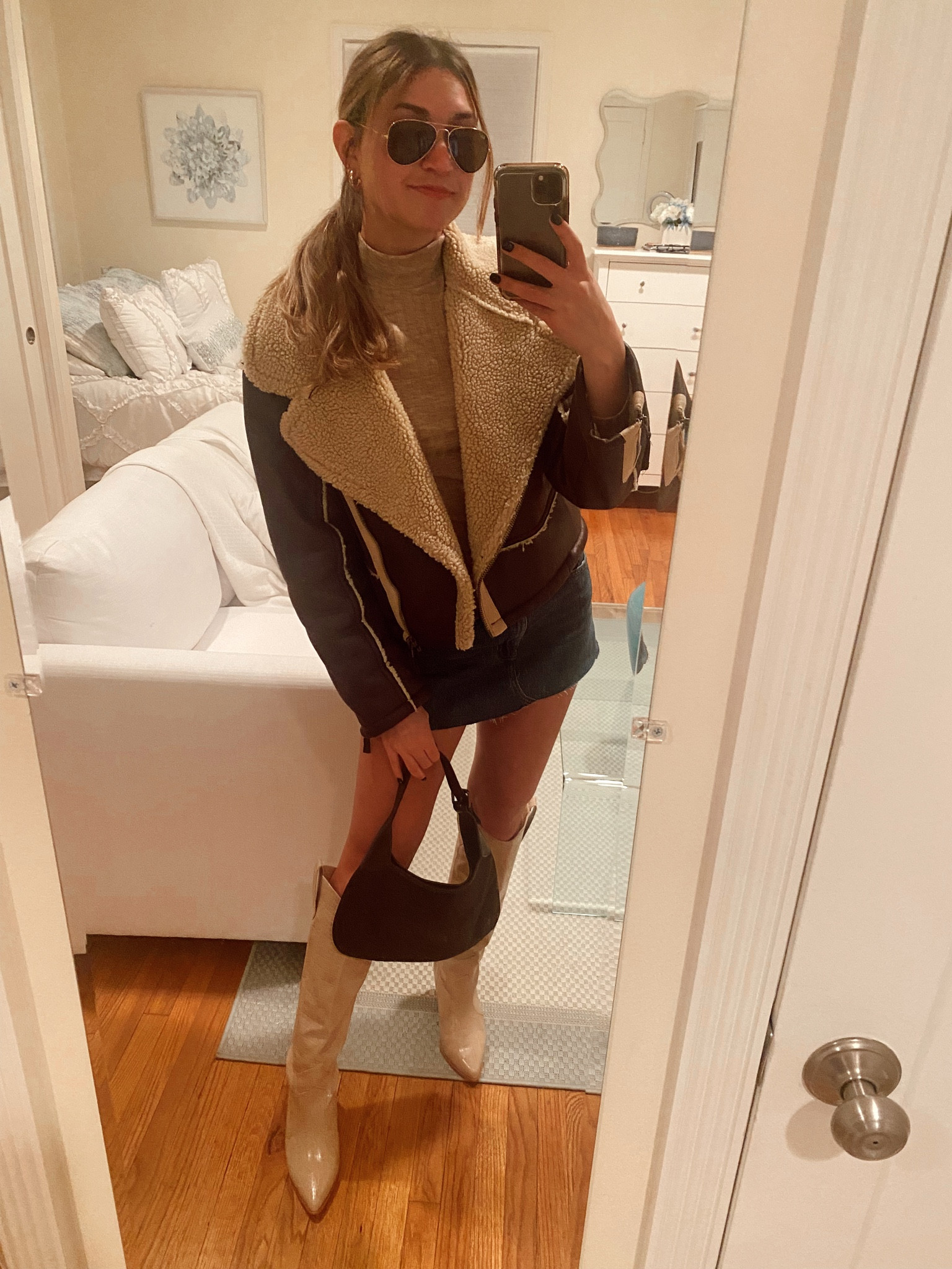 Fun winter outfit! Jean skirt with a tan mock neck top and big shearling jacket! Topped off with Ray bans, boots, and shoulder purse🐻 

#LTKSeasonal #LTKstyletip #LTKfit