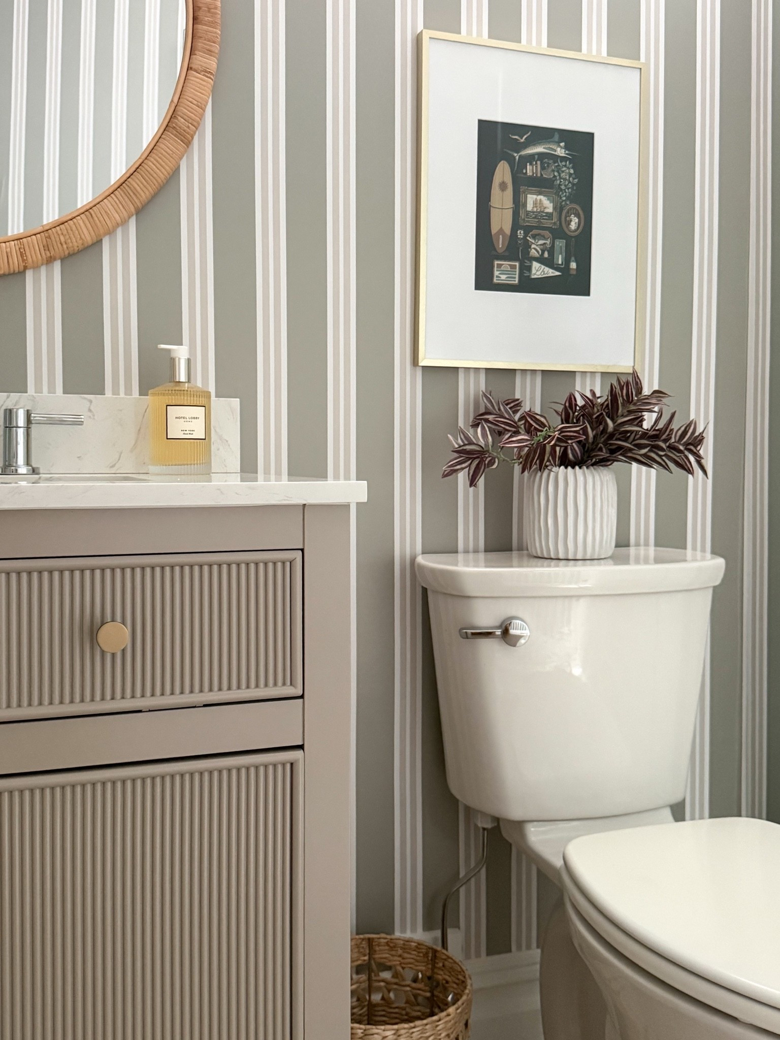 This powder room corner shows how the smallest details can make a space feel complete. The striped wallpaper, coastal artwork, textured vase, and layered greenery add so much personality while keeping the room feeling classic and elevated.

powder room decor, bathroom styling, striped wallpaper, bathroom wall art, small bathroom ideas, coastal bathroom decor, vanity styling, decorative vase, bathroom design inspiration, timeless home decor, neutral interiors, girlonthehudson

#LTKdayinmylife #LTKSeasonal #LTKHome