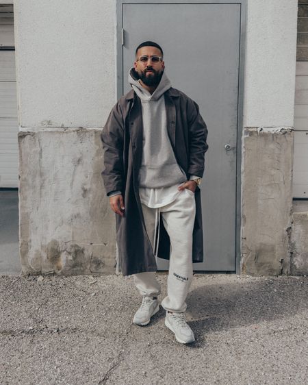 ESSENTIALS Long Coat in 'Off Black’ (size M) and Core Collection Sweatpants in ‘Heather Oatmeal’ (size M). FEAR OF GOD Eternal Collection hoodie in ‘Gray’ (size M). FEAR OF GOD x BARTON PERREIRA glasses in ‘Matte Taupe’. FEAR OF GOD x NIKE Air Skylon 2 in ‘Light Bone’ (size 9.5US). A relaxed and elevated men’s look that’s in a tonal grey and monochromatic vibe. A neutral outfit that’s layered for Spring. 

#LTKmens #LTKstyletip #LTKunder100