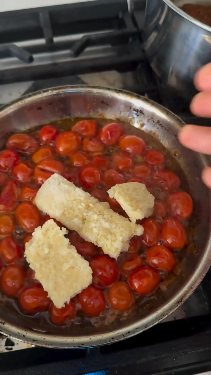 Garlicky, Slightly Spicy Tomato Oil 🍅✨

I rarely finish my grape tomatoes in time… they always end up wrinkly, a little mushy, and honestly—I lose interest. But what started as a quick “let me not waste these” experiment turned into a must-have in our home.

I love that you can give older tomatoes a little glow-up and turn them into something so flavorful—and something that actually lasts longer in the fridge without going bad.

We use this for everything:
pasta (think aglio e olio vibes), eggs in the morning, avocado toast, even quesadillas. And yes—my kids are obsessed too.

Ingredients
• About-to-go grape or cherry tomatoes
• Organic extra virgin olive oil (enough to fully drench the tomatoes)
• Salt, to taste
• 1–2 tbsp crushed garlic
• Crushed red pepper flakes (optional, but highly recommend for a little kick)

Instructions
1. On low–medium heat, add your olive oil and tomatoes. Cook for about 5 minutes.
2. Add salt and red pepper flakes, then cook for another 3 minutes.
3. Stir in the garlic and cook for 5 more minutes, until the tomatoes are soft, jammy, and easily crushed.
4. Let it cool completely, then store in the fridge.

Hope you try it! I personally love making the pasta (add some protein of your choice) 🫶🏻