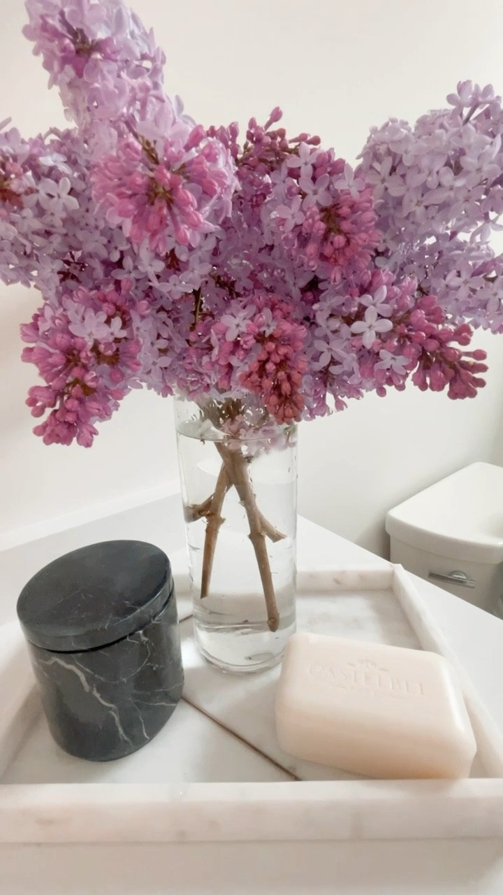 Bathrooms are hard to decorate, but adding fresh flowers can really brighten up the space. Our mirror is from CB2 & is 48” big. Fills up the space perfect with our 10ft ceilings. 

All bathroom decorations are tagged. 
#bathroomdecor #bathroom #decor #design #flowers  

#LTKSeasonal #LTKFind #LTKunder100