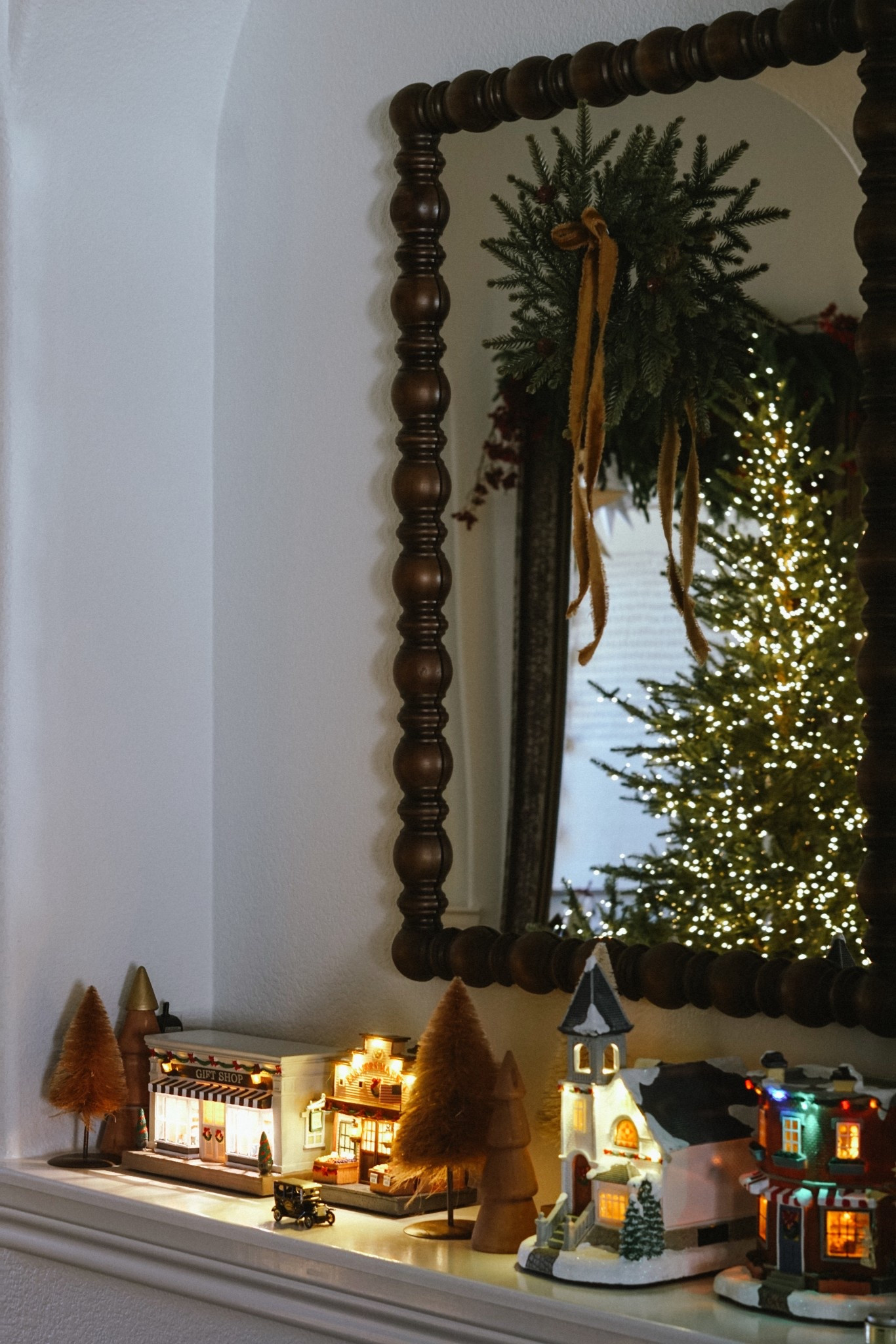 Christmas village, wood beaded mirror, bells, Christmas decor 

#LTKHoliday #LTKHome #LTKSeasonal