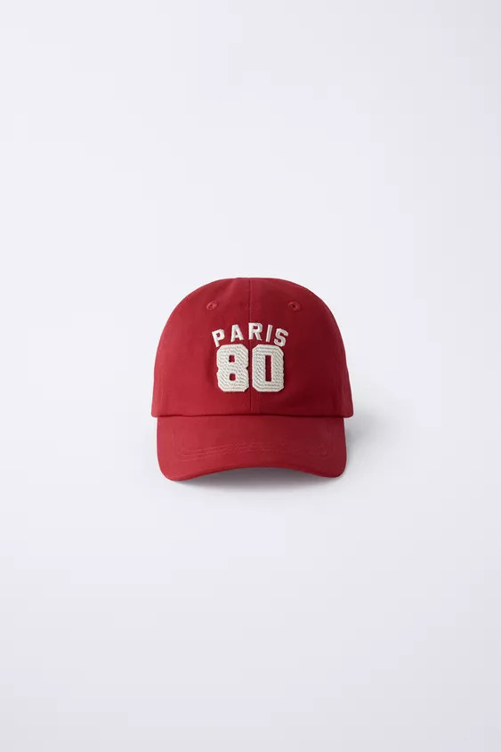 Cap with adjustable adhesive closure at the back of the neck. Varsity text embroidered on the fro... | Zara US