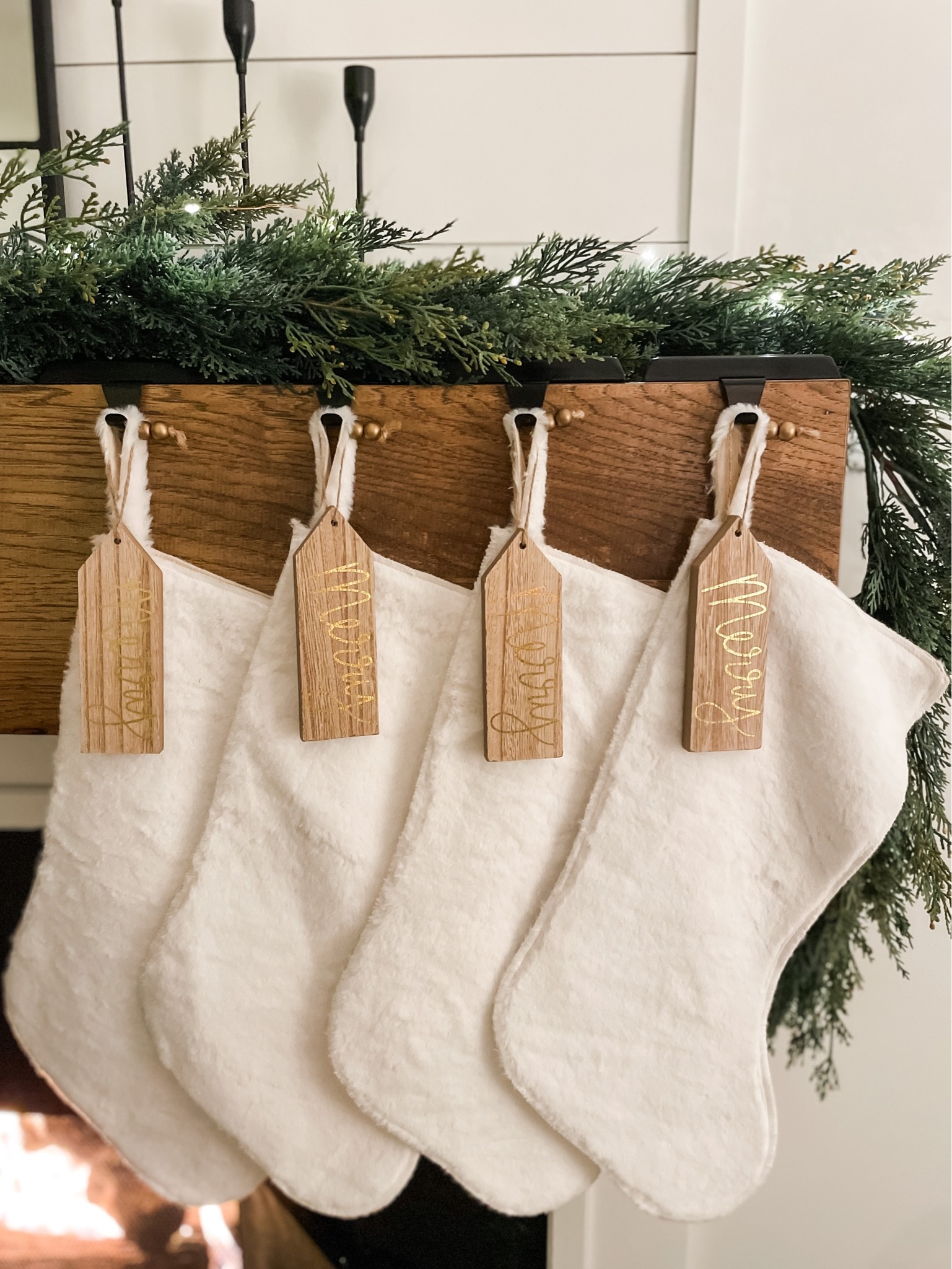 Christmas fireplace mantel decor.  Neutral stockings.  Christmas stockings.  White stockings.  Cable knit stockings.  White cream stockings.  Neutral Christmas home decor.  Christmas garland.  Spruce garland.  Target style home.  Studio McGee Christmas decor.  Black stocking holders.  Wooden gift tags.

#LTKSeasonal #LTKhome #LTKHoliday