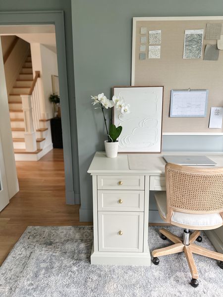 Home office, white executive desk with file stirage, cane rolling desk chair, Studio McGee for target art, linen pin board. Paint color is Booothbay Gray

#LTKhome #LTKstyletip #LTKBacktoSchool