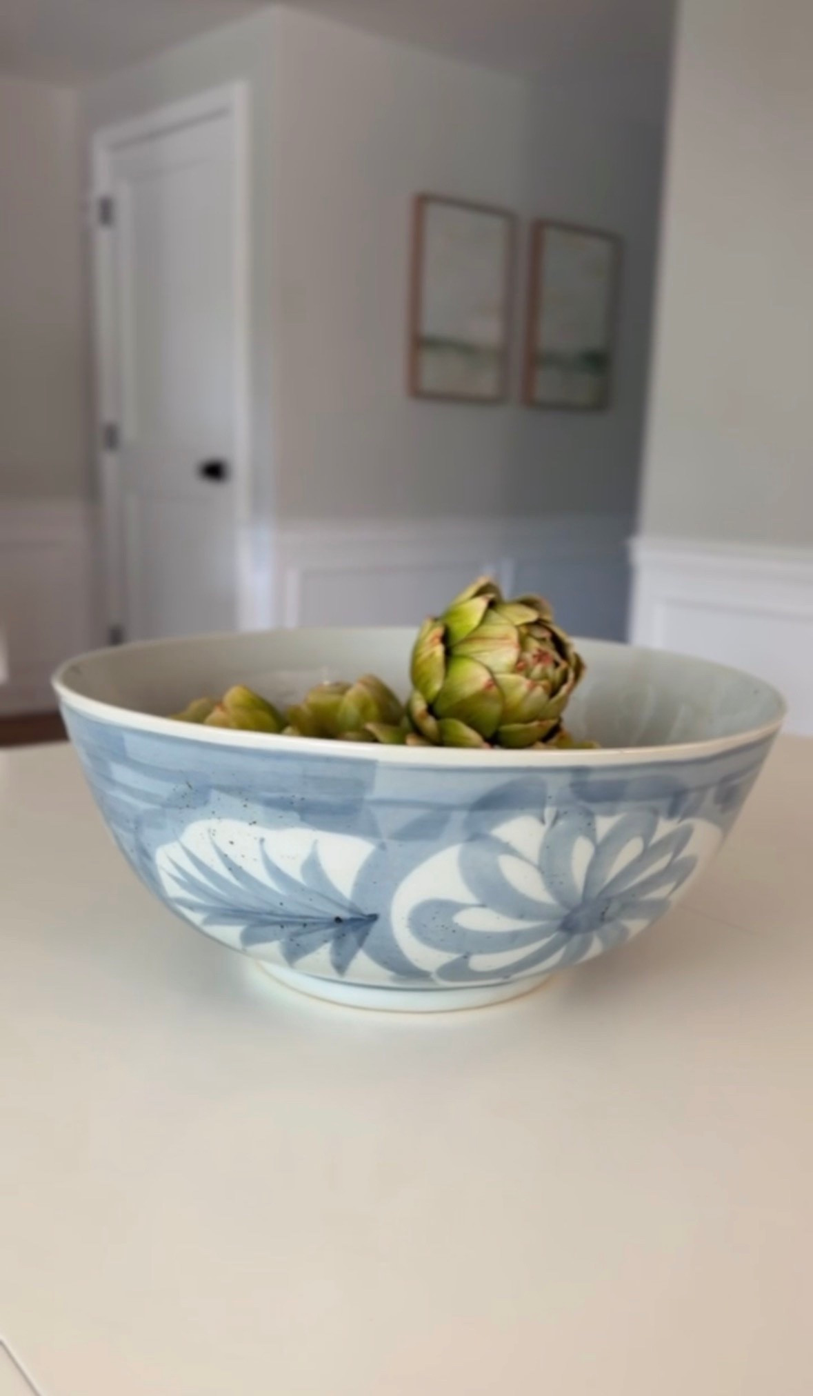 This blue and white decorative bowl is perfect for a table centerpiece, console tables, or even a kitchen counter. I popped in some faux artichokes and I love the look!

#LTKHome