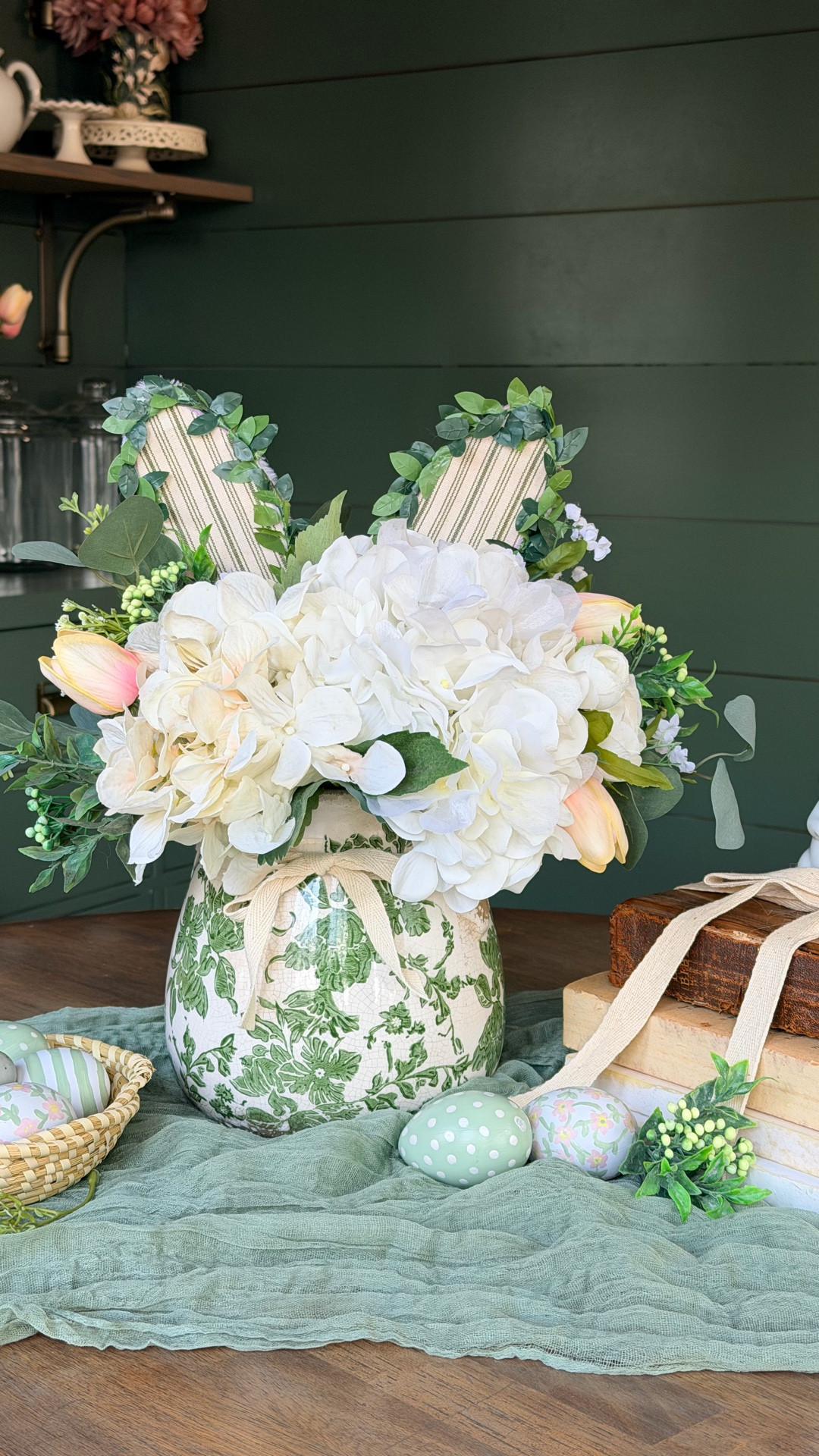 Spring centerpiece, styled and ready 🌿🐰

I customized inexpensive bunny ears with ribbon to match this green toile vase, then built the arrangement with hydrangeas and soft tulips for movement. It’s playful yet elevated.

Save this for your Easter table!

#LTKspring #LTKHome