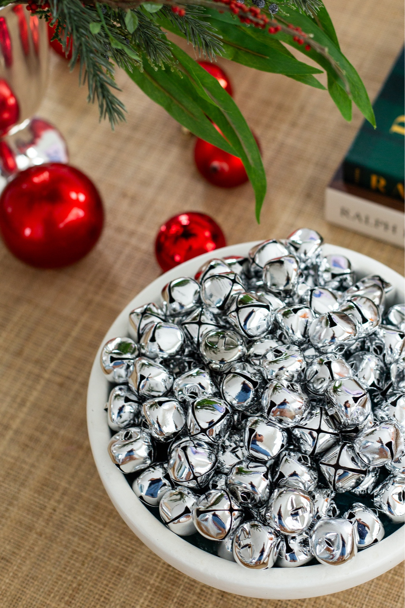 I love this jingle bell vase filler so much for Christmas! I filled the bowl with other stuff I had lying around and then just did a layer on top of the bells so I didn’t need as many. I’m using the small footed bowl on our rattan coffee table tray. I’ll also link the faux evergreen Christmas bundle, silver trophy case, red ornaments, and Ralph Lauren coffee table books. #ltkholiday #ltkhome #ltksalealert #ltkfindsunder50 #ltkfindsunder100 #ltkstyletip #ltkseasonal Christmas decorating ideas, classic holiday decor, preppy Christmas decorating, traditional Christmas decor

#LTKHoliday #LTKHome #LTKFindsUnder50