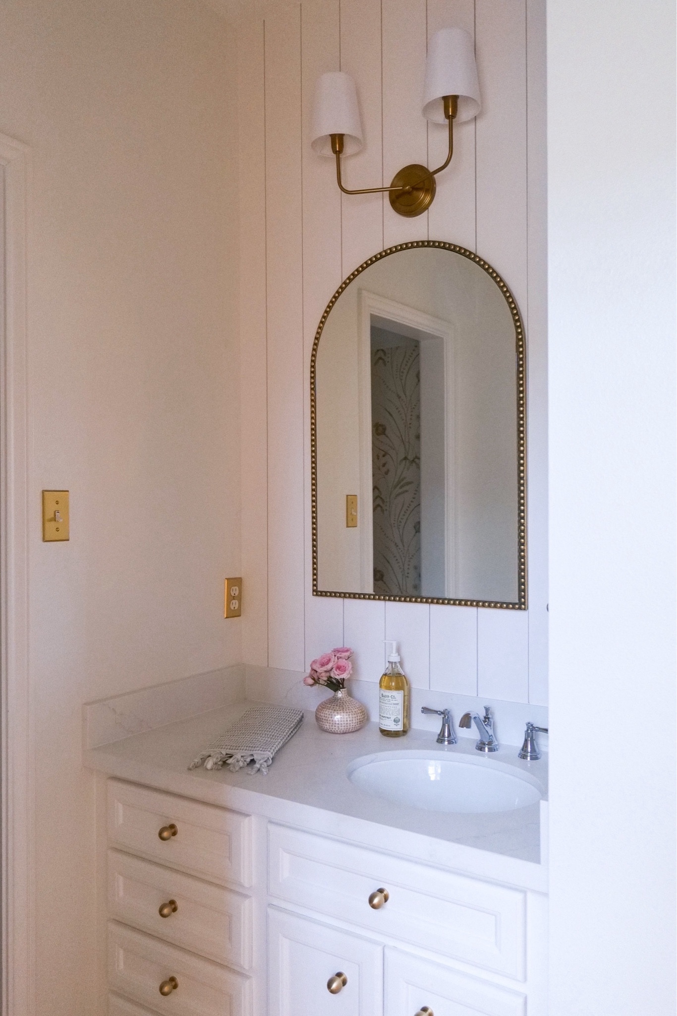 Mid remodel in all of our bathrooms right now 🤯 however here’s a sneak peek of the upstairs Jack & Jill bathroom half way point! 🤍🛁
We added new countertops, knobs, faucets, lights & mirror. We also added a fun shiplap wall that gives a small element of farmhouse that ties my traditional style into the true character of the house.
After our downstairs is completely done we will be redoing the floor. We had to take a small break because our downstairs has a mold issue we needed to address sooner. Love the updates we did here tho and can’t wait to see it with fresh tile soon! Head to stories for a reminder on how it started!

Knobs: @emtek_products 
Shiplap: @novobp
Faucet: @deltafaucet 
Lights: @safavieh

#LTKfindsunder50 #LTKhome