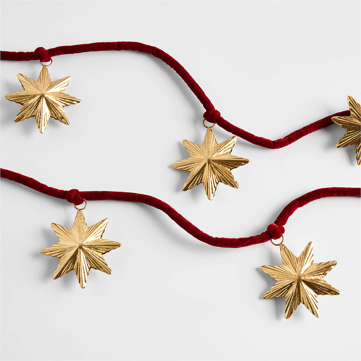 Brass Star & Red Velvet Christmas Garland | Crate & Barrel | Crate & Barrel