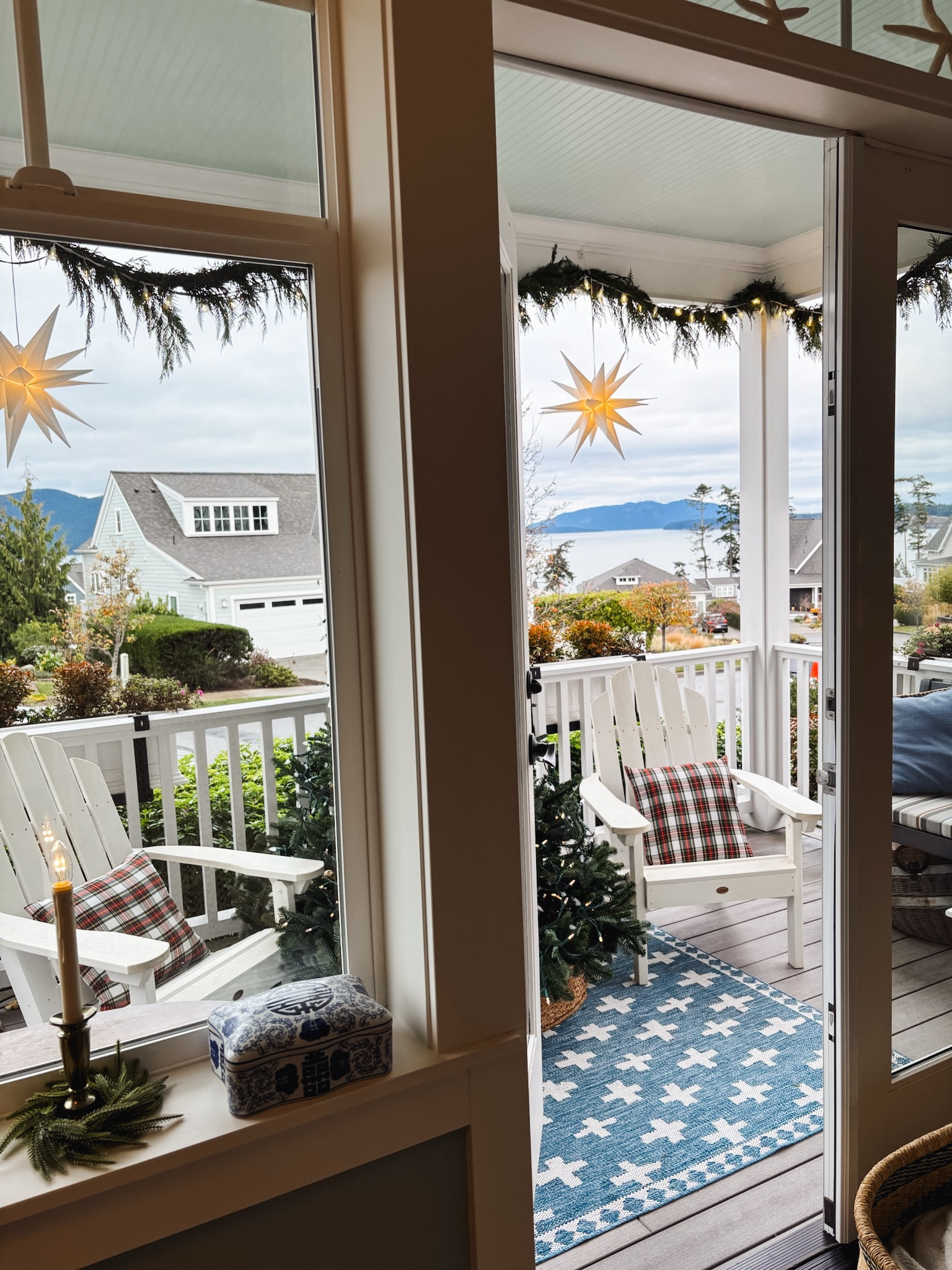 Blue and white outdoor rug, similar Adirondack chairs, lit hanging stars, plaid pillows, window candle and greenery, star on our tree 

#LTKSeasonal #LTKHoliday #LTKHome