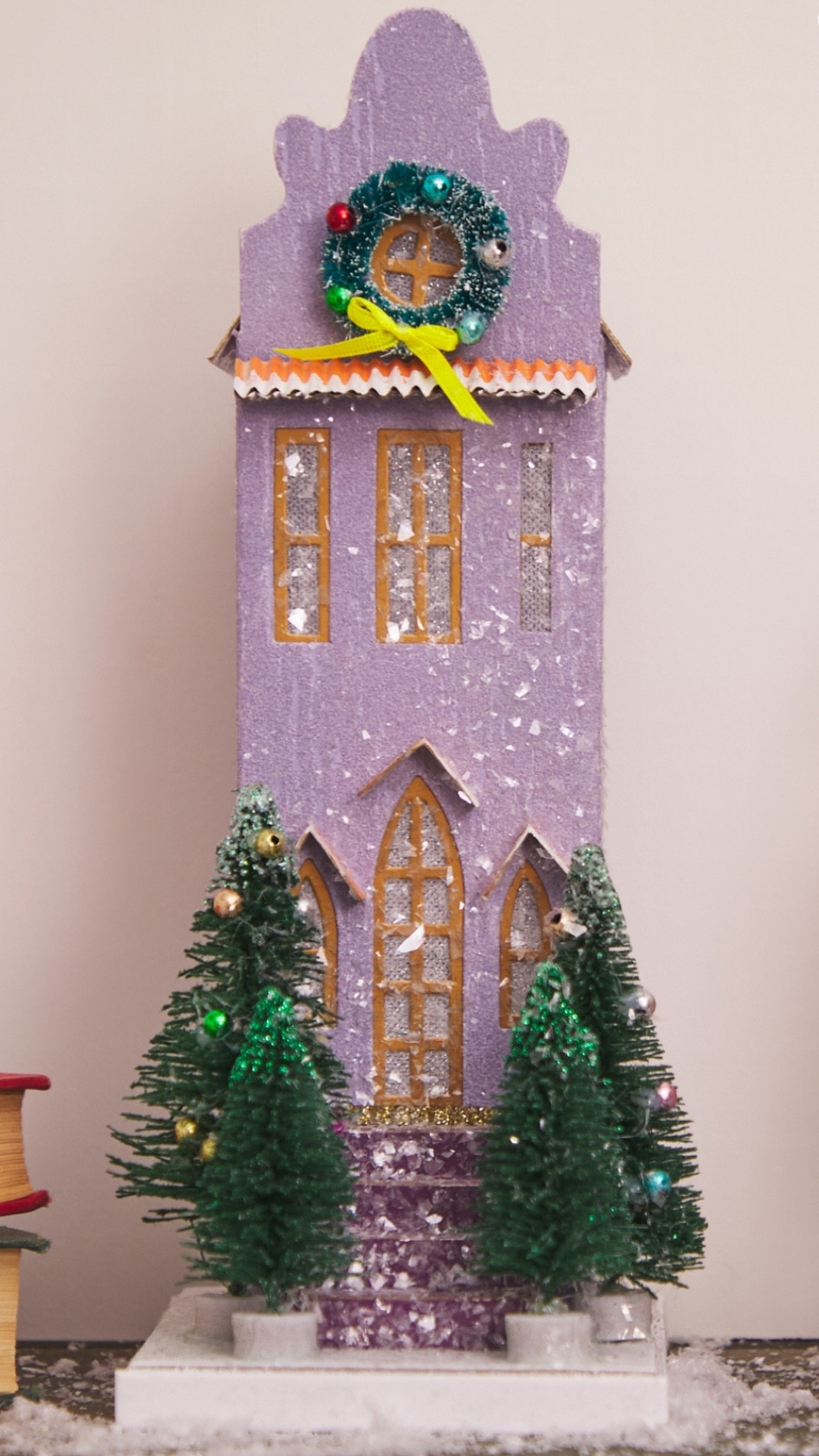 The Purple Christmas Village House is a charming, three-story holiday home that radiates festive magic. Its striking gold glitter roof catches the light, adding a dazzling touch to any Christmas village display. The house’s porch is beautifully decorated with four majestic Christmas trees, creating a warm and inviting entrance. A sparkling wreath hangs in the front window, completing the enchanting holiday scene and making this house the perfect centerpiece for any festive decor collection.

#LTKHome #LTKSeasonal #LTKHoliday
