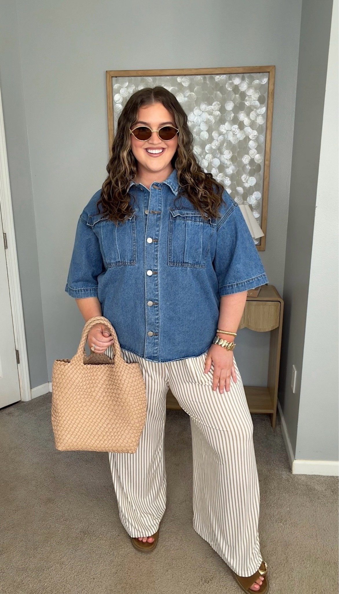 Springtime casual chic is what I’m calling this adorable plus size approved outfit. These striped pants are so comfortable; wear lounging around or with this denim top for a more elevated look. Everything about this screams $$$ but it’s all affordable and won’t break the bank. 
Denim shirt sleeve top, neutral tote, brown sandals

#LTKSeasonal #LTKPlusSize