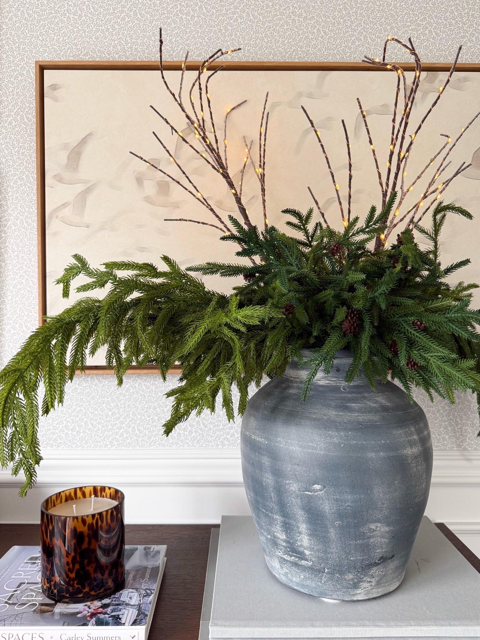 Starting to bring in the holiday greens, and I love how this arrangement feels festive without being too traditional. The oversized greenery, lit branches, weathered vase, and tortoise shell candle make such a beautiful statement together.

holiday greenery, Christmas stems, faux evergreen branches, holiday vase styling, Christmas home decor, lit branches, tortoise shell candle, console table decor, seasonal home accents, holiday decorating ideas, collected home decor, girlonthehudson

#LTKSeasonal #LTKHome #LTKdayinmylife