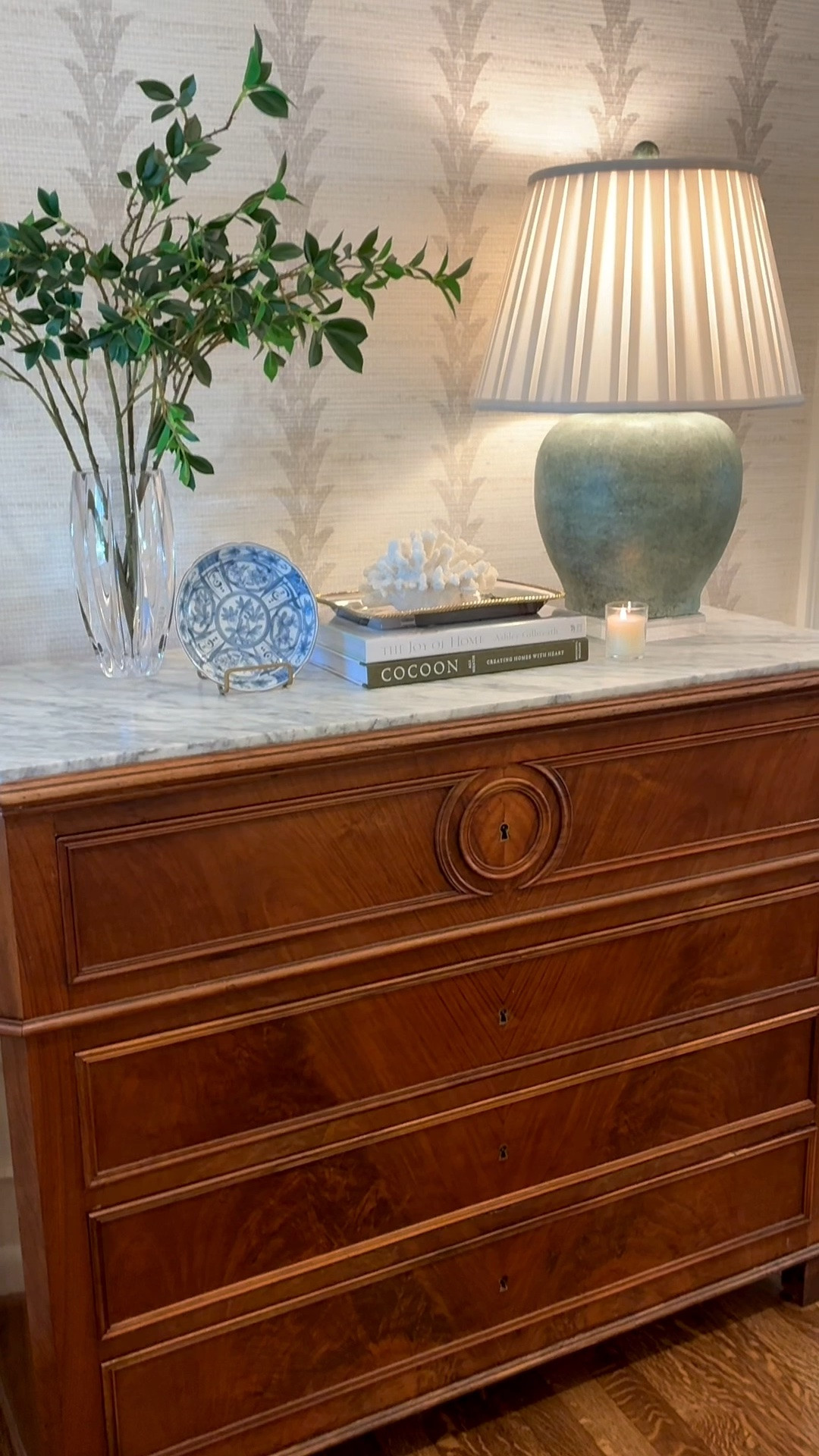 Slowly but surely adding/finding the perfect layers to add to my entry! I am so in love with this chest, wallpaper, and semi flush light.  Next up mirror and runner! You can shop this post over on my LTK.

Linked what I could and similar options for the other items.
My green lamp is sitting on an acrylic riser and I changed out the shade it came with to a pleated one.  My wallpaper is in the option Wheatfield.