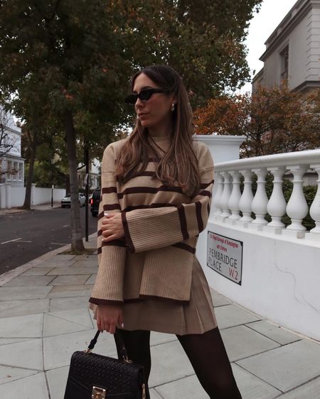 Tis the season of cosy jumpers 🤎
neutral outfit, cosy outfit, London street style, striped jumper, autumn aesthetic, wide sleeve sweater, striped sweater, black work bag, pleated mini skirt

#LTKSeasonal #LTKstyletip #LTKeurope