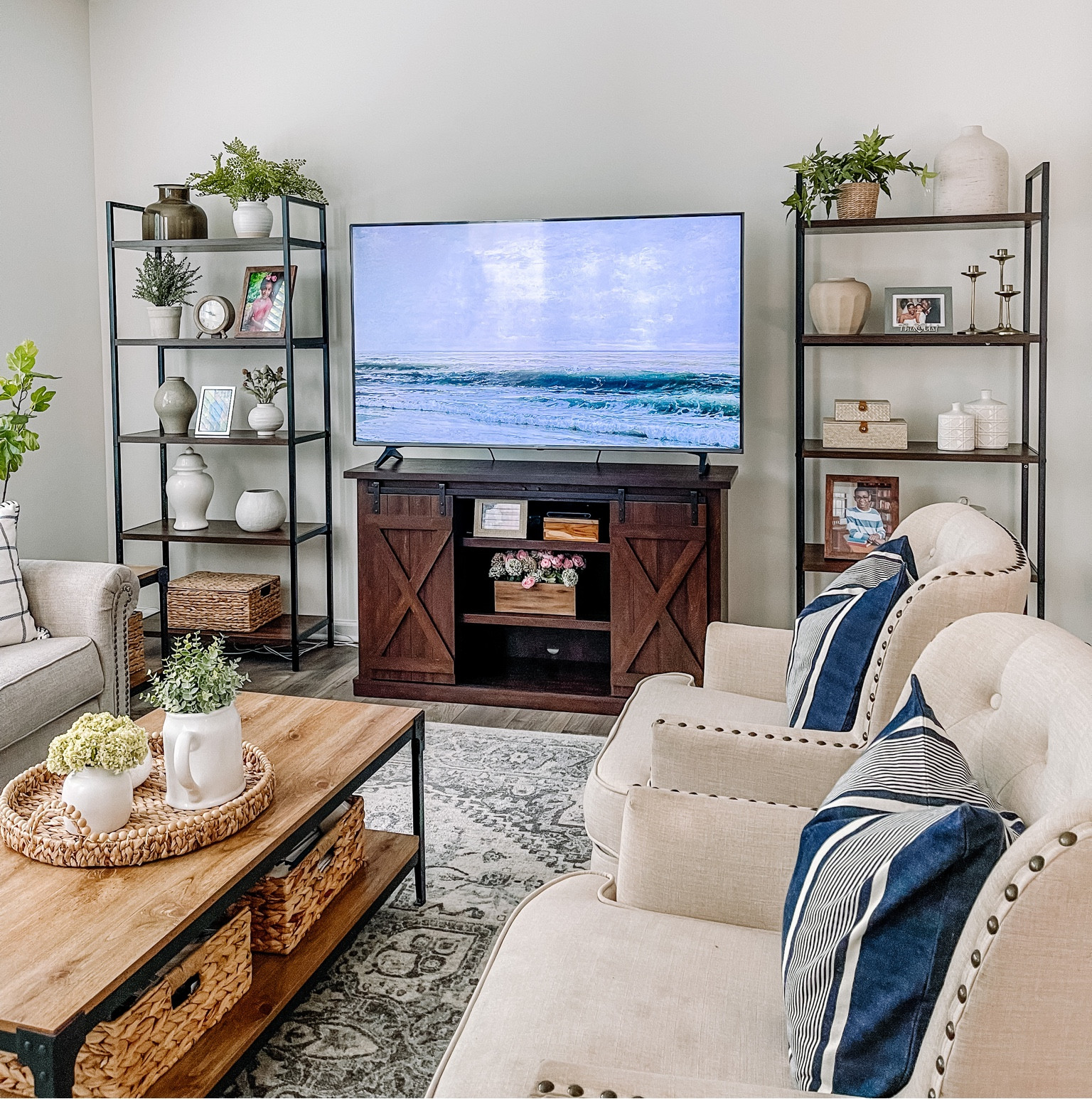 Neutral living room / styled shelves / bookshelf / nailhead trim chair / coffee table / sliding door tv stand / coffee table  decor 

#LTKhome
