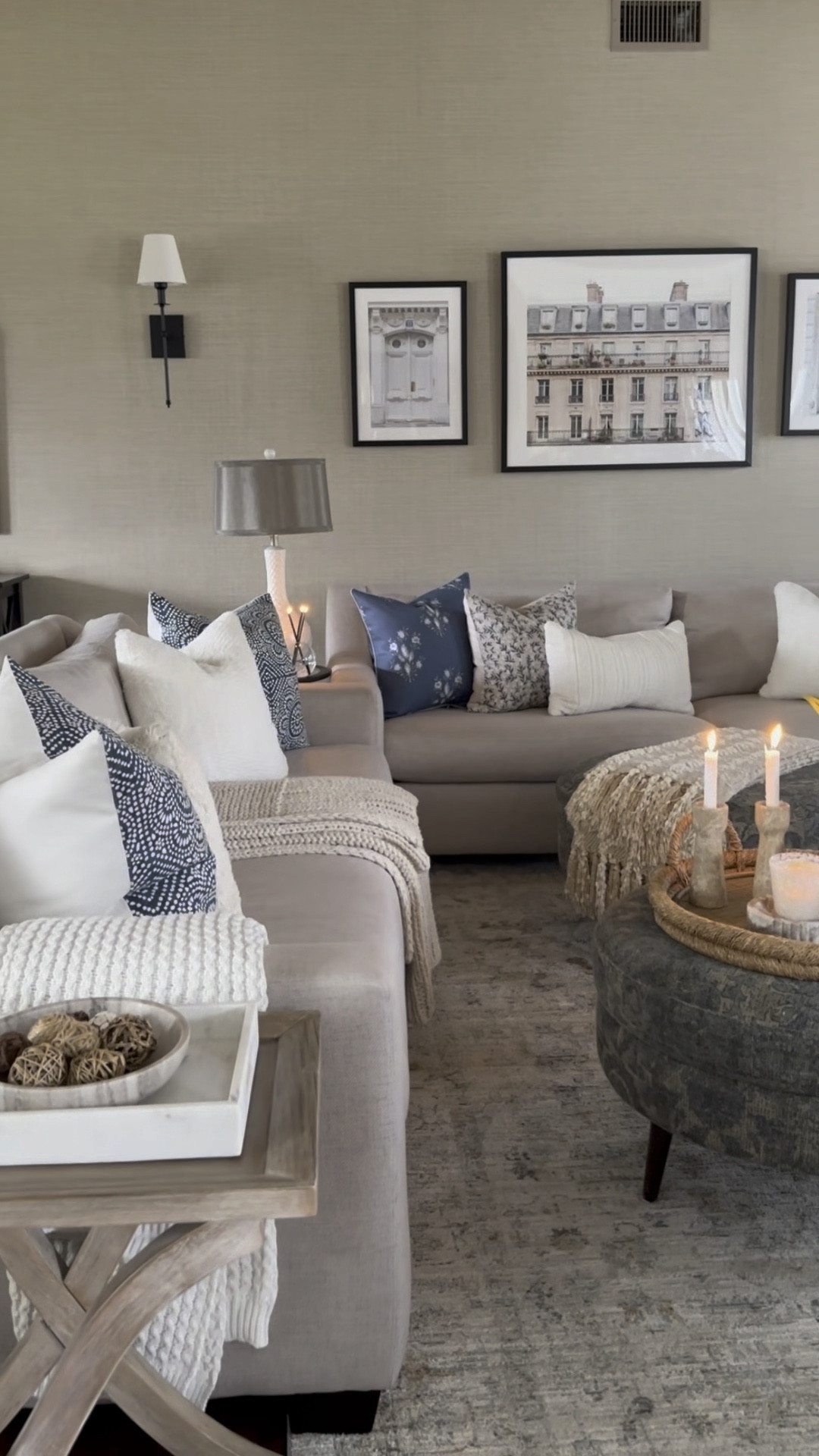 Living room styling. Sofa, area rug, cozy and comfy throw pillows and blankets, Parisian artwork, tray, vase, marble candleholders, sconce set, candle. 

#LTKhome #LTKsalealert #LTKfindsunder50