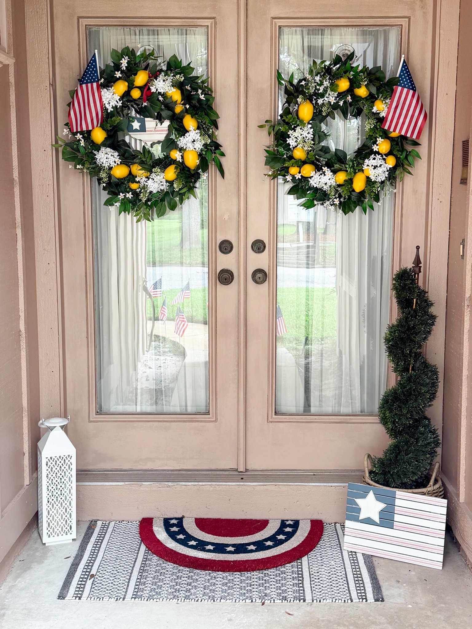 July 4 red white and blue porch decor ideas. In the process of moving , packing and cleaning up new place. Plan to paint the front door and get new handles with smart lock. Left my lemon wreaths up cause buying 2 wreaths instead of just one has gotten costly using flags. A white lantern and my fave rugs for layering. #frontporch #porchdecor #redwhiteandbluedecor #flagrug #lantern #lemonwreath #flagdecor #july4 #topiary

#LTKSeasonal #LTKHome