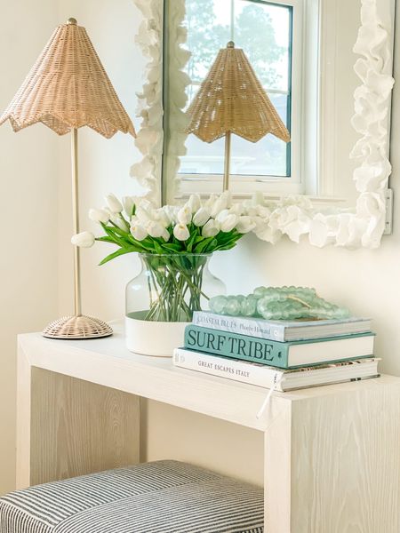 *Restock alert on this set of rattan parasol lamps* Spring decorating in our former entryway! This slim console table is perfect for this right space. I decorated for spring with this scalloped wicker lamp, my favorite faux tulips, my colorblock vase, coastal coffee table books, recycled glass beads, striped ottoman cube and a white coral mirror! . 

entryway decor, spring decorating ideas

#ltkhome #ltkseasonal #ltkfindsunder50 #ltkfindsunder100 #ltkstyletip #ltksalealert  

#LTKSeasonal #LTKhome #LTKsalealert