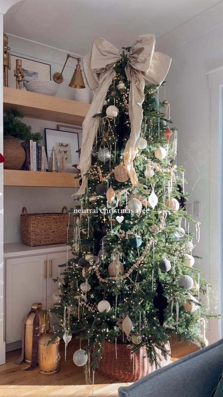 neutral christmas tree magic 🤎 | the bow was the inspo and the show stopper of this tree! mixed in the  twinkle with golds and browns and wooden elements, added tinsel for that extra pop & love how this years tree turned out! ✨🦌 

*bells are a @homegoods find! 🔔

save + share for neutral inspo 🧑🏼‍🎄
#christmas #christmastree #ornaments #neutralchristmas #christmasdecorations #christmastime #tistheseason #anthrohome 

#LTKHoliday #LTKSeasonal #LTKHome