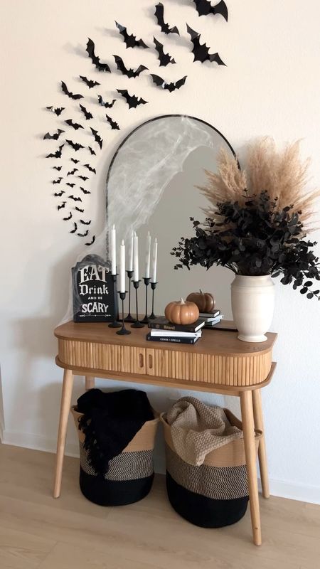 Halloween entryway console table decor // #ltkfall Halloween decor, Halloween decorations, bats, black arch mirror, spiderwebs, pumpkin, pampas, black eucalyptus, candlesticks, black and tan, blankets, storage baskets, Amazon home, Target home, home decor

#LTKhome #LTKSeasonal #LTKHalloween