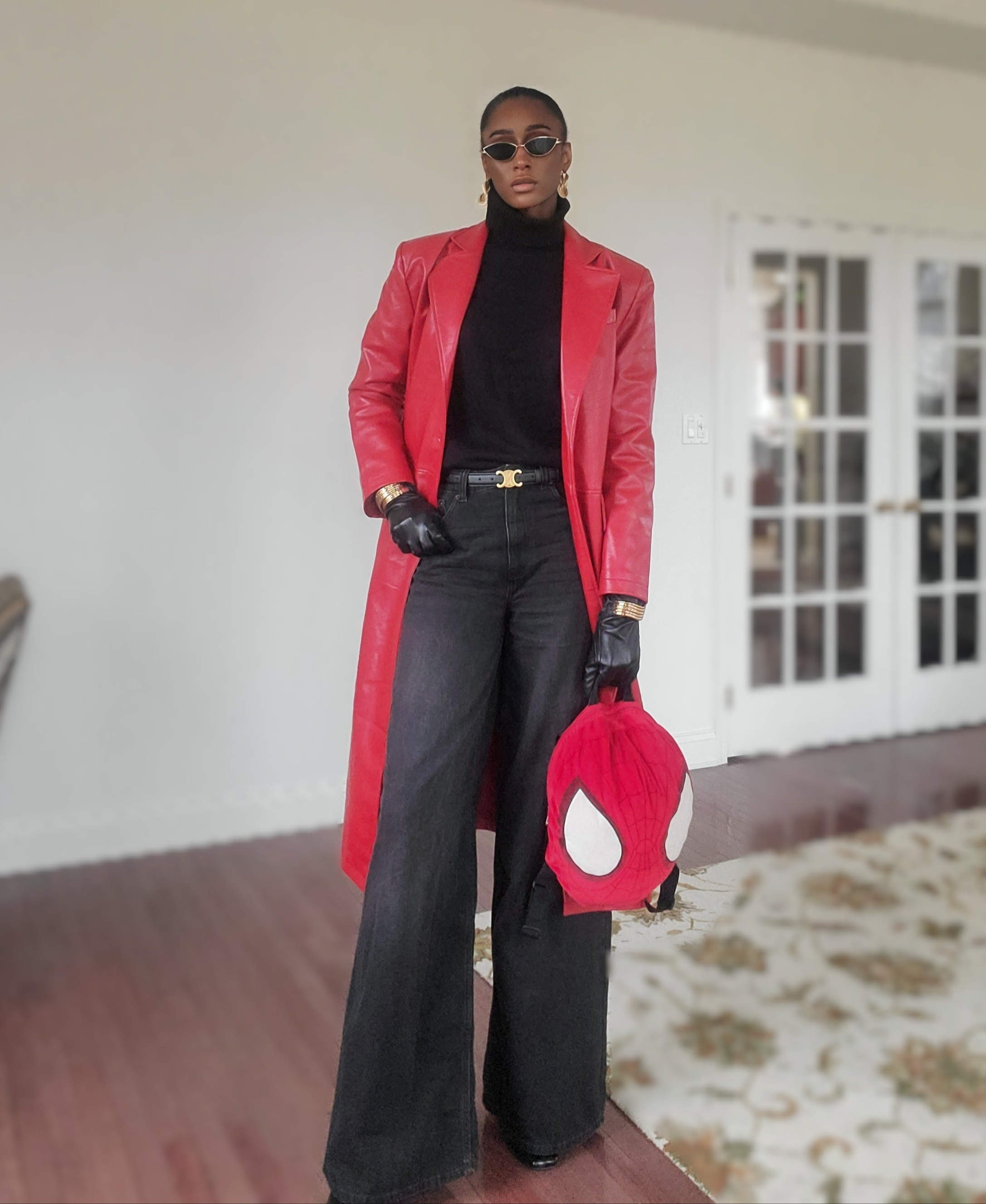 Redefining main character energy with this bold look! 🔥 Featuring a red faux leather trench, black turtleneck, wide-leg jeans, and a playful Spider-Man bag for a touch of fun. Accessorized with gold statement earrings, chic sunglasses, and leather gloves for that dramatic finish. Shop this Leo Rising-inspired vibe now! 🕶️✨ #LTKStyle #BoldFashion #LeoRisingLooks 

#LTKStyleTip