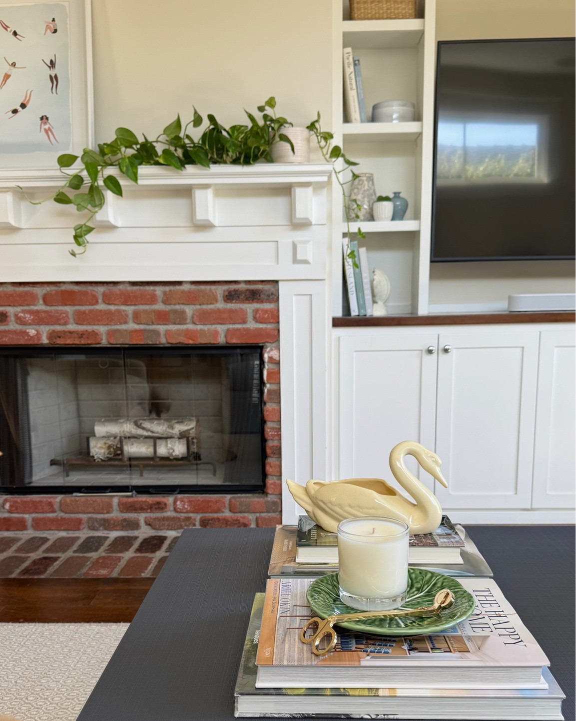 The living room shelves & fireplace details.
Check out the full home makeover process on my YouTube channel!

home decor, living room makeover, coastal cottage aesthetic, coastal home decor, cottage style, coastal living room, neutral home decor, cozy living room, classic home decor, timeless interiors, relaxed coastal style, light and airy interiors, blue and green decor, blue and green living room, comfortable living room, traditional home decor, cottage living room, family room decor, coastal cottage, elegant home decor, layered neutrals, natural textures, classic coastal decor, living room inspiration, interior design inspiration, interior designer, green swivel chair, green accent chair, swivel chair, accent chair, blue couch, blue sofa, blue pleated couch,  blue pleated sofa, blue slipcover couch, blue slipcover sofa, slipcovered sofa, linen sofa, skirted sofa, coastal blue sofa, upholstered armchair, slipcovered armchair, coastal accent chair, wood coffee table, navy blue coffee table, dark blue coffee table, woven table lamp, decorative throw pillows, gallery wall, white fireplace mantel, brick fireplace, built-in shelving, open shelving decor, ceramic vases, coastal coffee table styling, decorative coffee table books

#LTKvlog #LTKdayinmylife #LTKHome